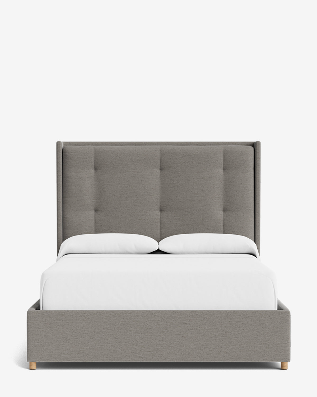The Ria Bed features a modern gray upholstered design with a tall, customizable tufted headboard, white bedding, and two pillows, displayed against a plain white background by McGee & Co.