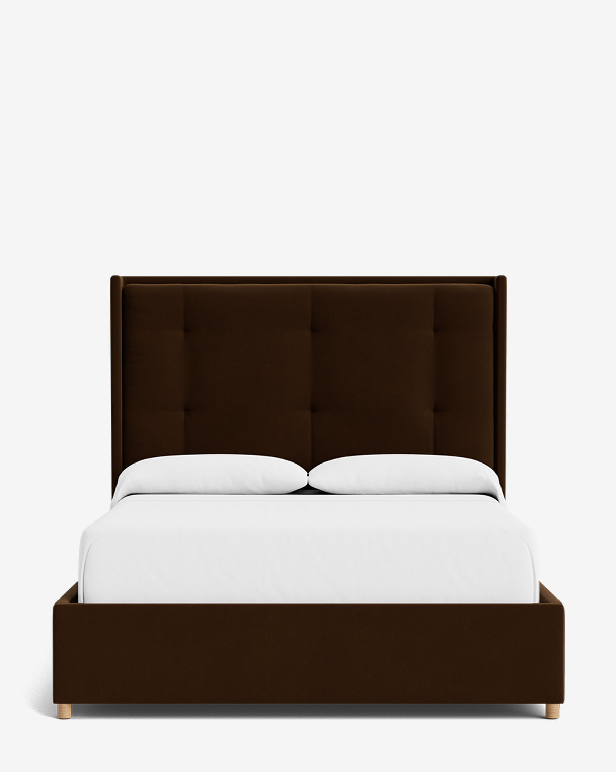 The Ria Bed is a modern dark brown upholstered bed featuring a customizable tall rectangular tufted headboard, white bedding, and two white pillows, displayed against a plain white background by McGee & Co.