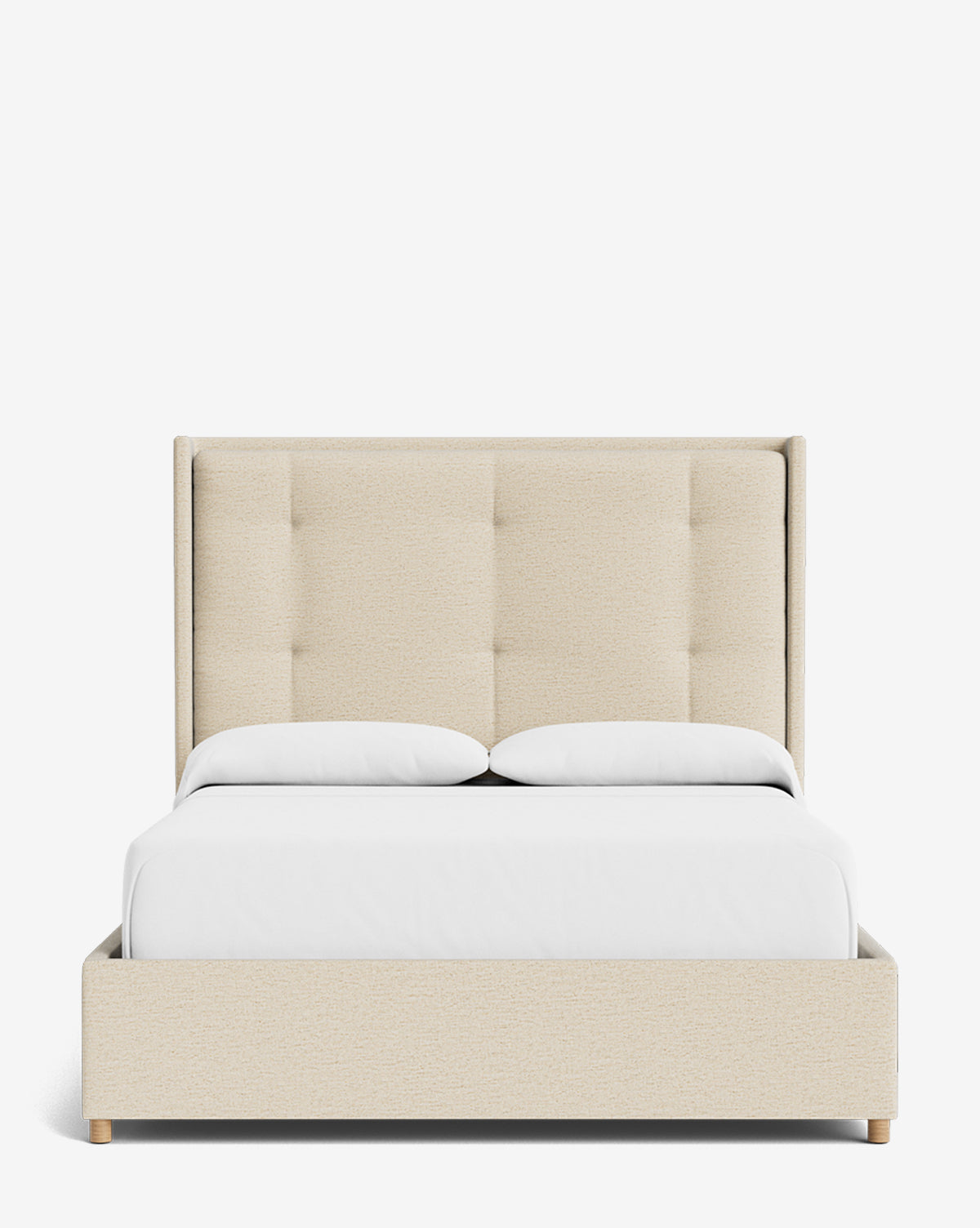 The Ria Bed features a cream-colored customizable upholstered frame, a tall tufted headboard, two white pillows, white bedding, and wooden legs, all showcased against a plain white background by McGee & Co.