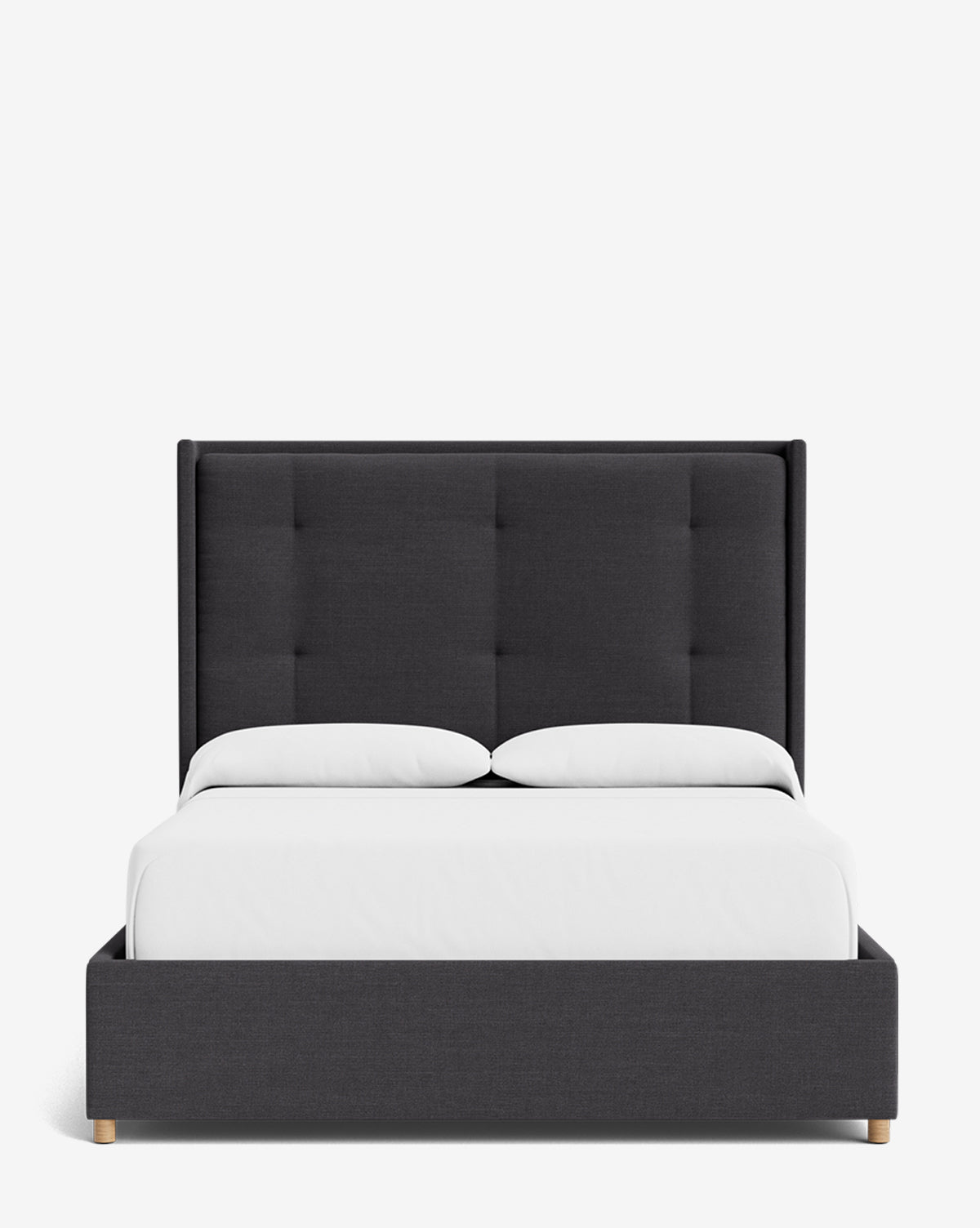The Ria Bed features a modern design with a tall, dark gray tufted headboard, white bedding, and two pillows, customizable to suit your style. Shown from the front against a plain white background by McGee & Co.