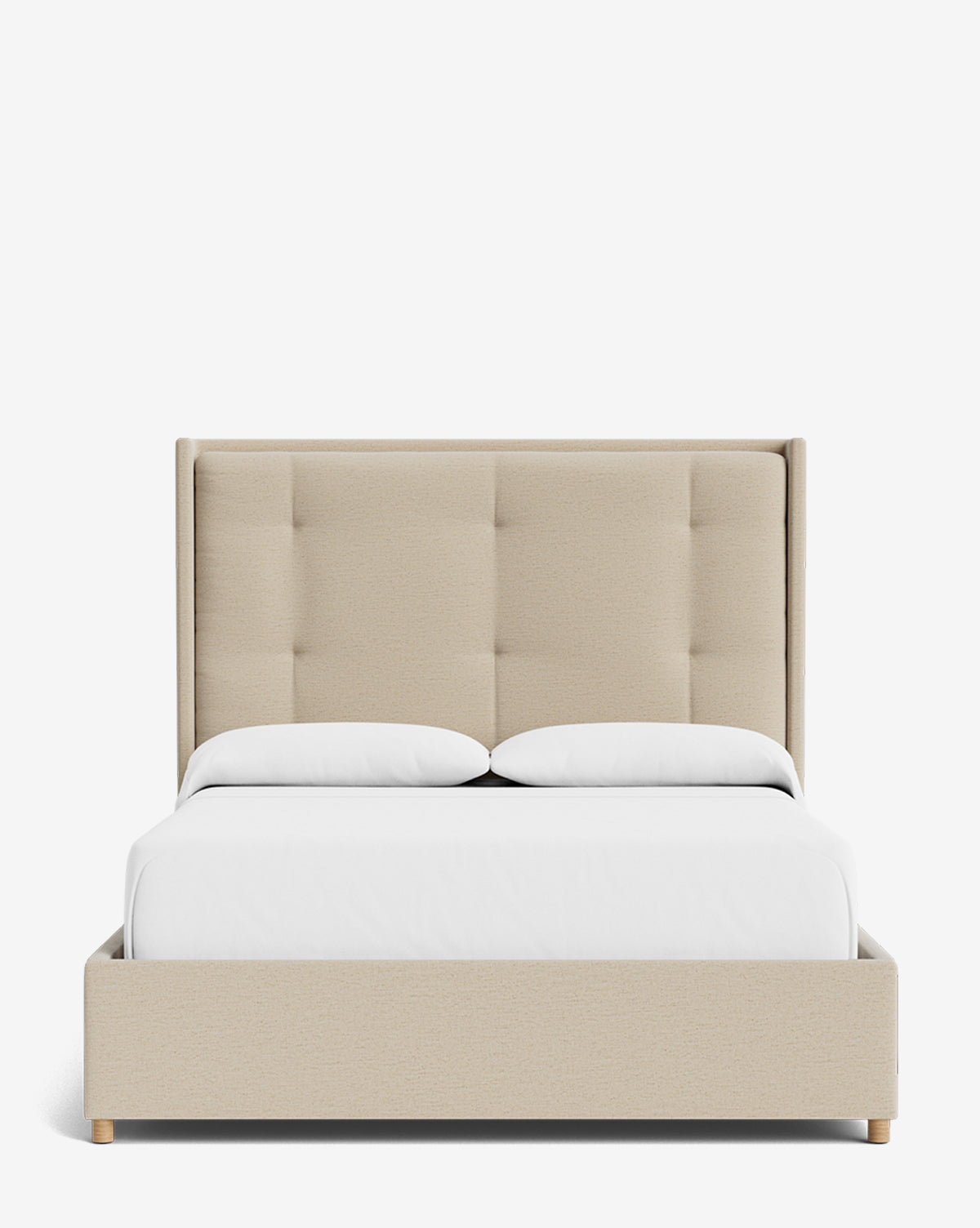The Ria Bed, a customizable beige upholstered bed with a tall, tufted headboard, is styled with crisp white bedding and two pillows, set against a plain white background by McGee & Co.