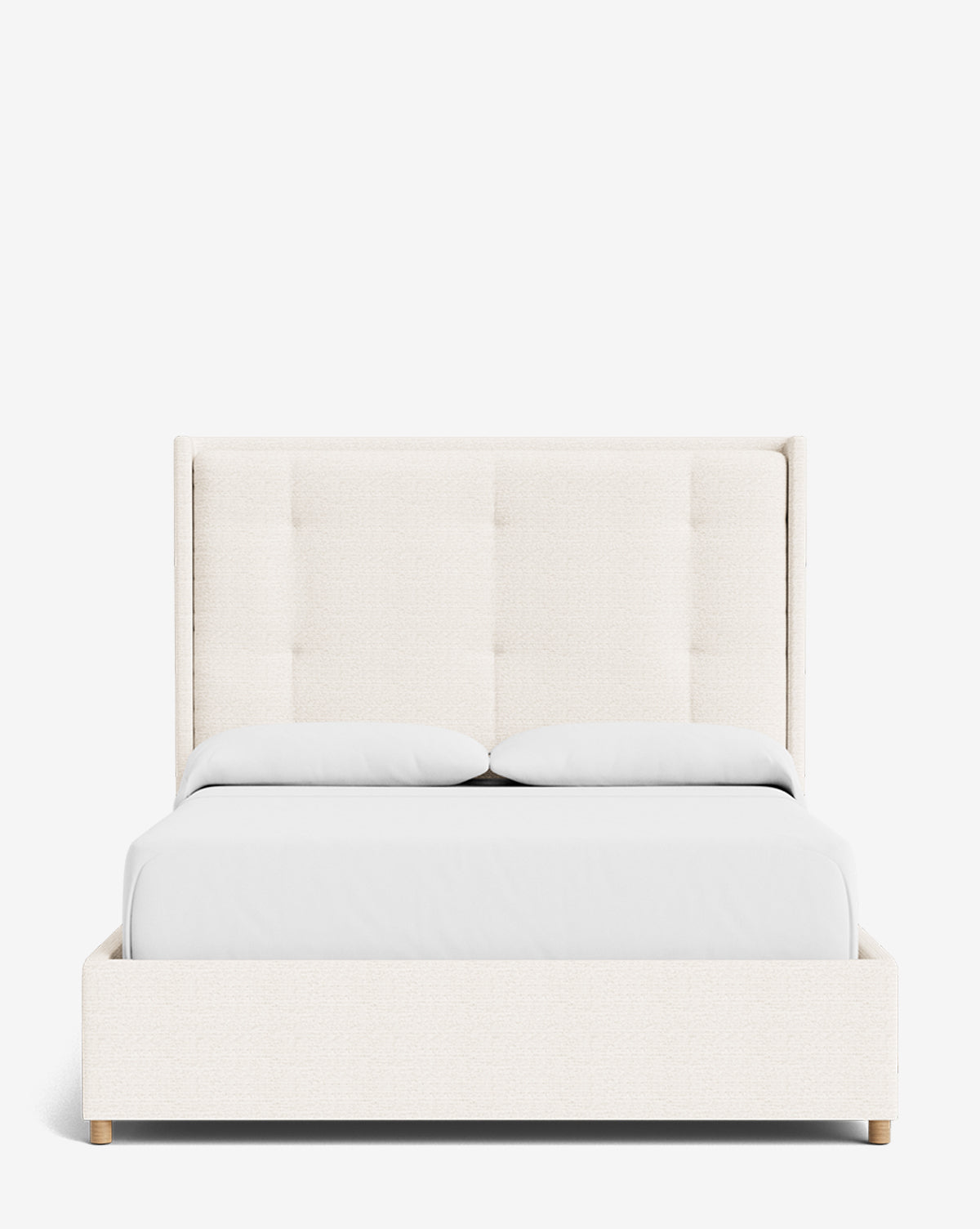 The Ria Bed features a modern upholstered frame with a tall tufted headboard, white bedding, and two pillows. Its light wooden legs and clean, minimalist design allow it to easily complement any space. Displayed against a plain white background by McGee & Co.