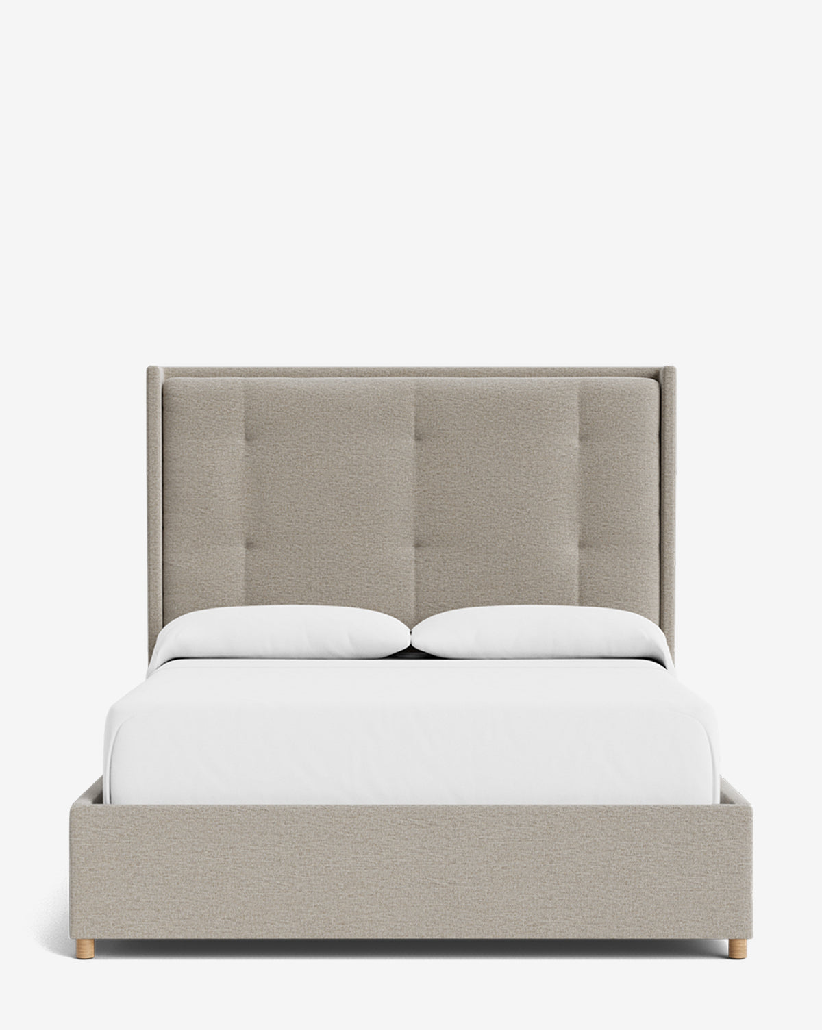The Ria Bed is a modern upholstered design with a customizable tall tufted headboard, matching base, and light wooden legs. Shown with white bedding and two pillows, it’s photographed from the front against a plain white background by McGee & Co.