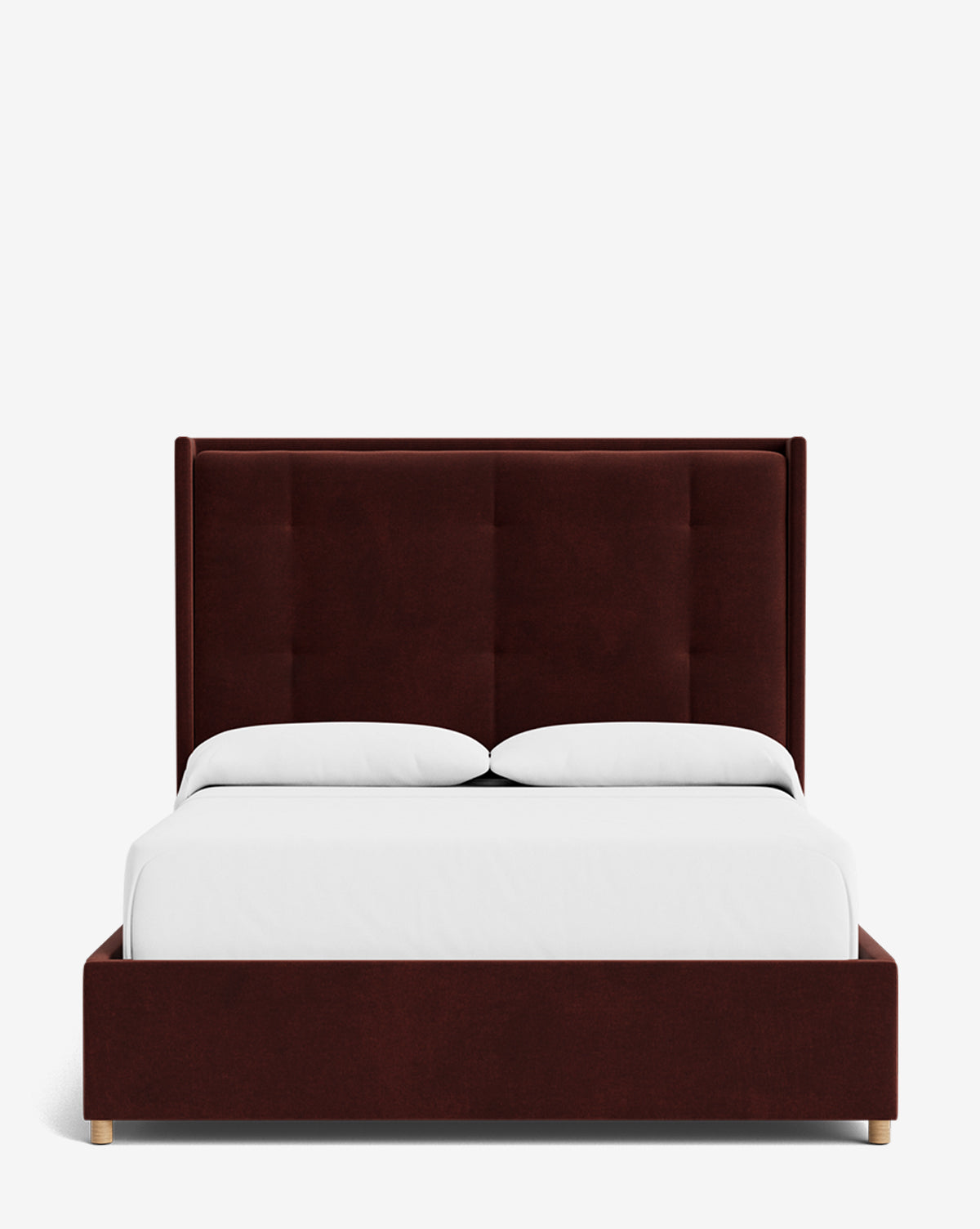 The Ria Bed features a tall, customizable maroon upholstered headboard and base, paired with white bedding and two pillows, displayed against a plain white background by McGee & Co.