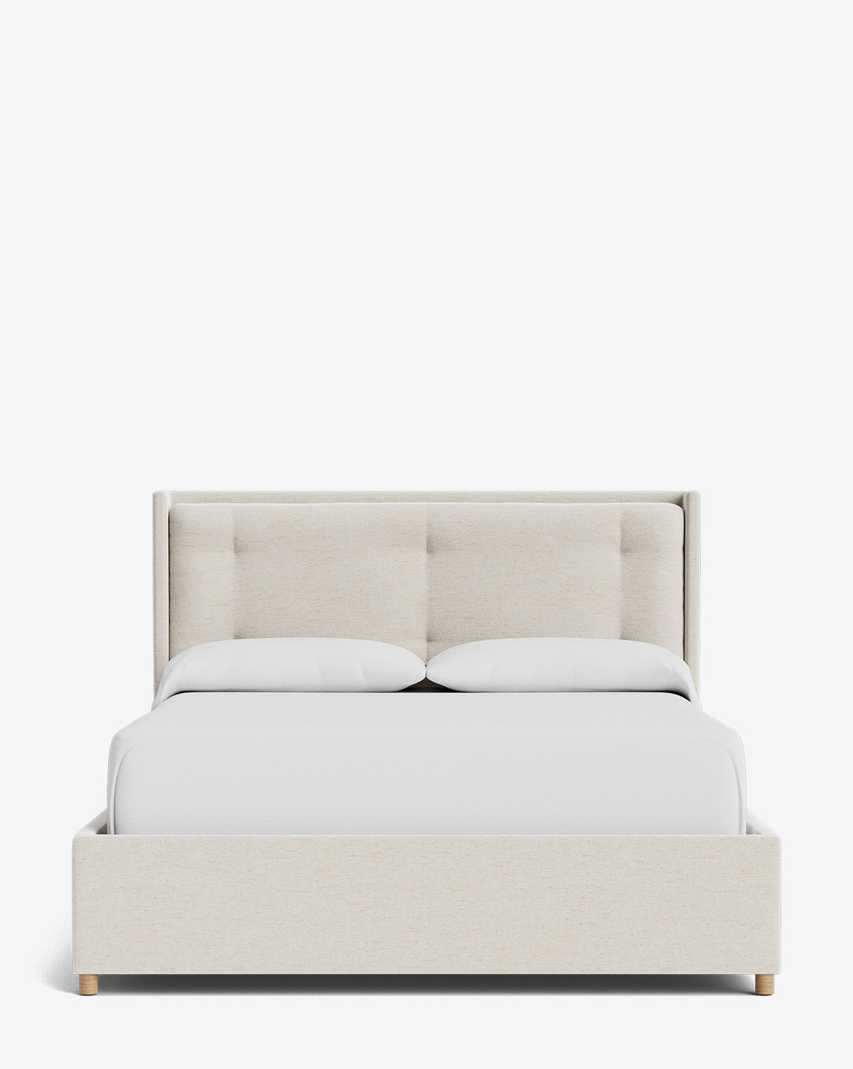 The Ria Bed Low Headboard, shown in light beige upholstery with a tufted headboard, white bedding, and two pillows, is displayed against a plain white background by McGee & Co.