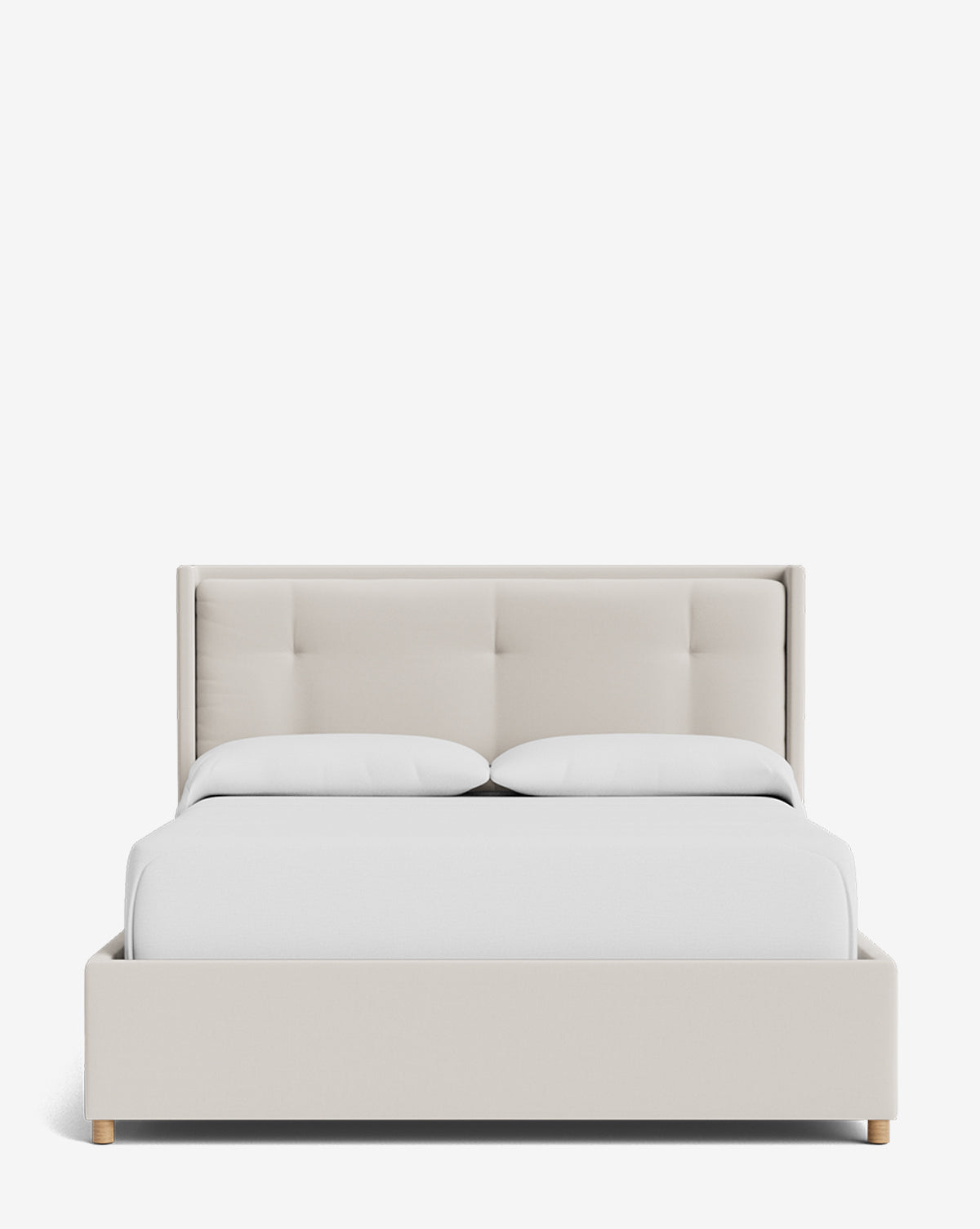 The Ria Bed Low Headboard is shown from the front, upholstered in light beige with a sleek frame and headboard, featuring two white pillows and white bedding against a plain white background by McGee & Co.