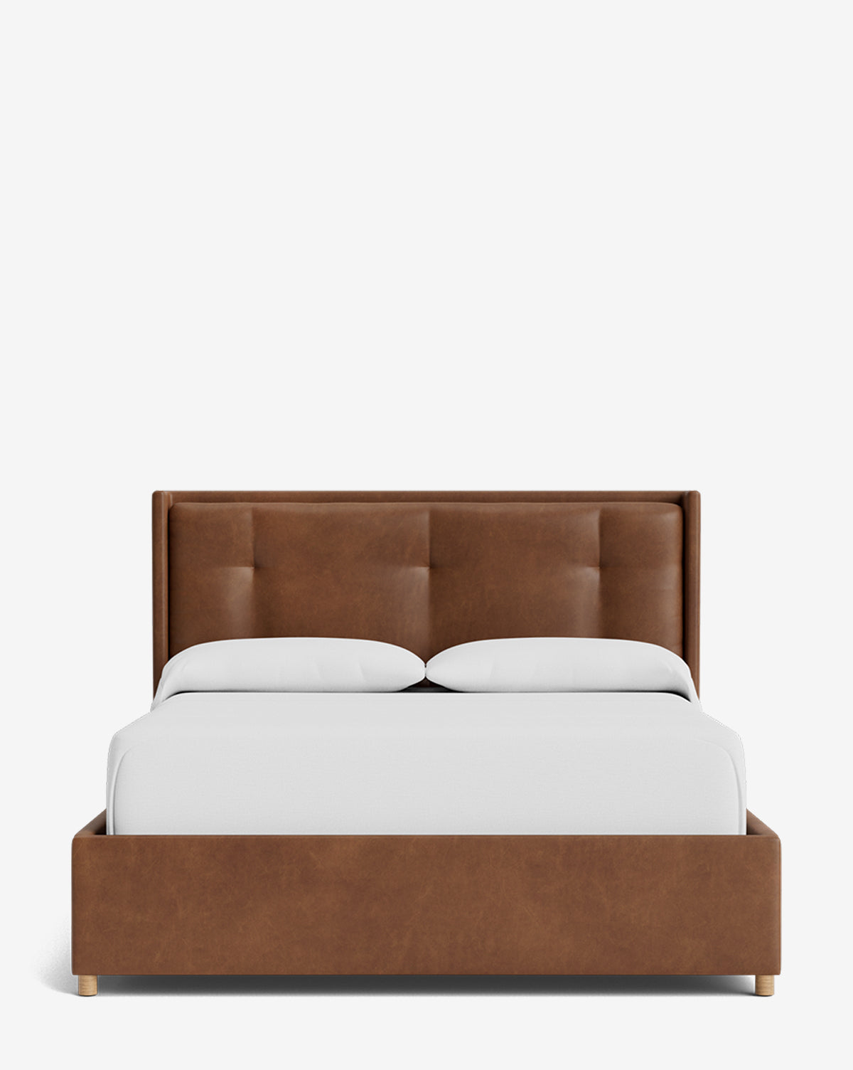 The Ria Bed Low Headboard is a modern upholstered bed with a brown, tufted headboard and frame, styled with crisp white bedding and two pillows on a plain white background, by McGee & Co.