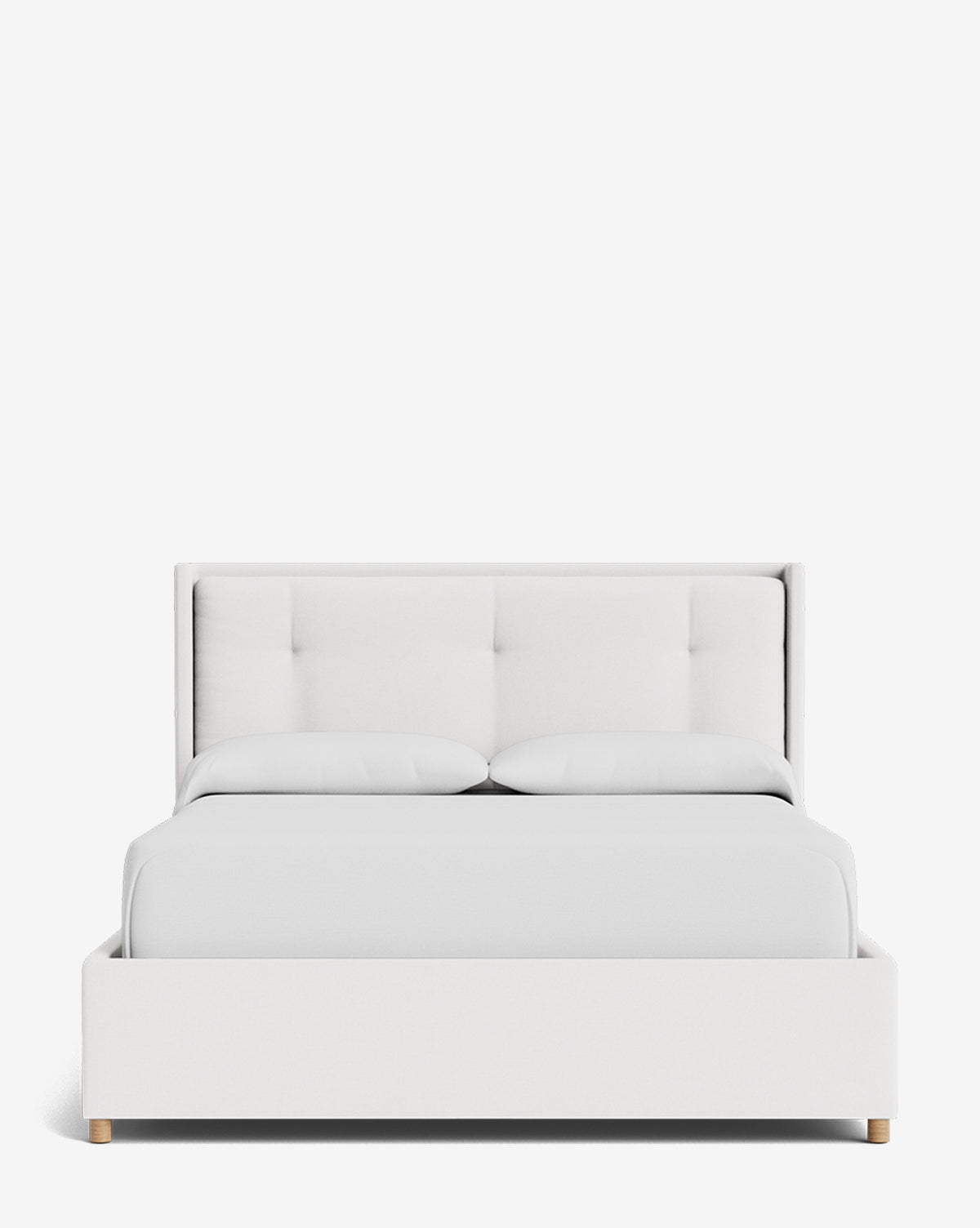 The Ria Bed Low Headboard is shown from the front against a white background, featuring clean lines, a tufted headboard, white bedding with two pillows, and small wooden legs by McGee & Co.