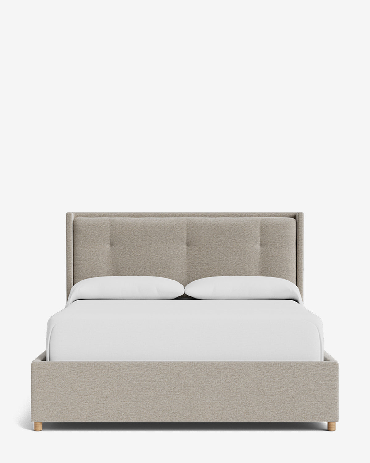 The Ria Bed Low Headboard is a beige upholstered bed with a tufted headboard and light wood legs, neatly made with white bedding and two pillows, displayed against a plain white background, by McGee & Co.