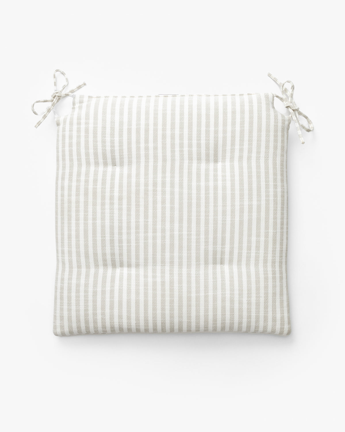The Credence Romany Counter Stool Cushion is a square linen cushion with beige and white stripes, four tufted points, and two pairs of ties—ideal for enhancing your Romany Counter Stool. Shown on a white background. McGee & Co.