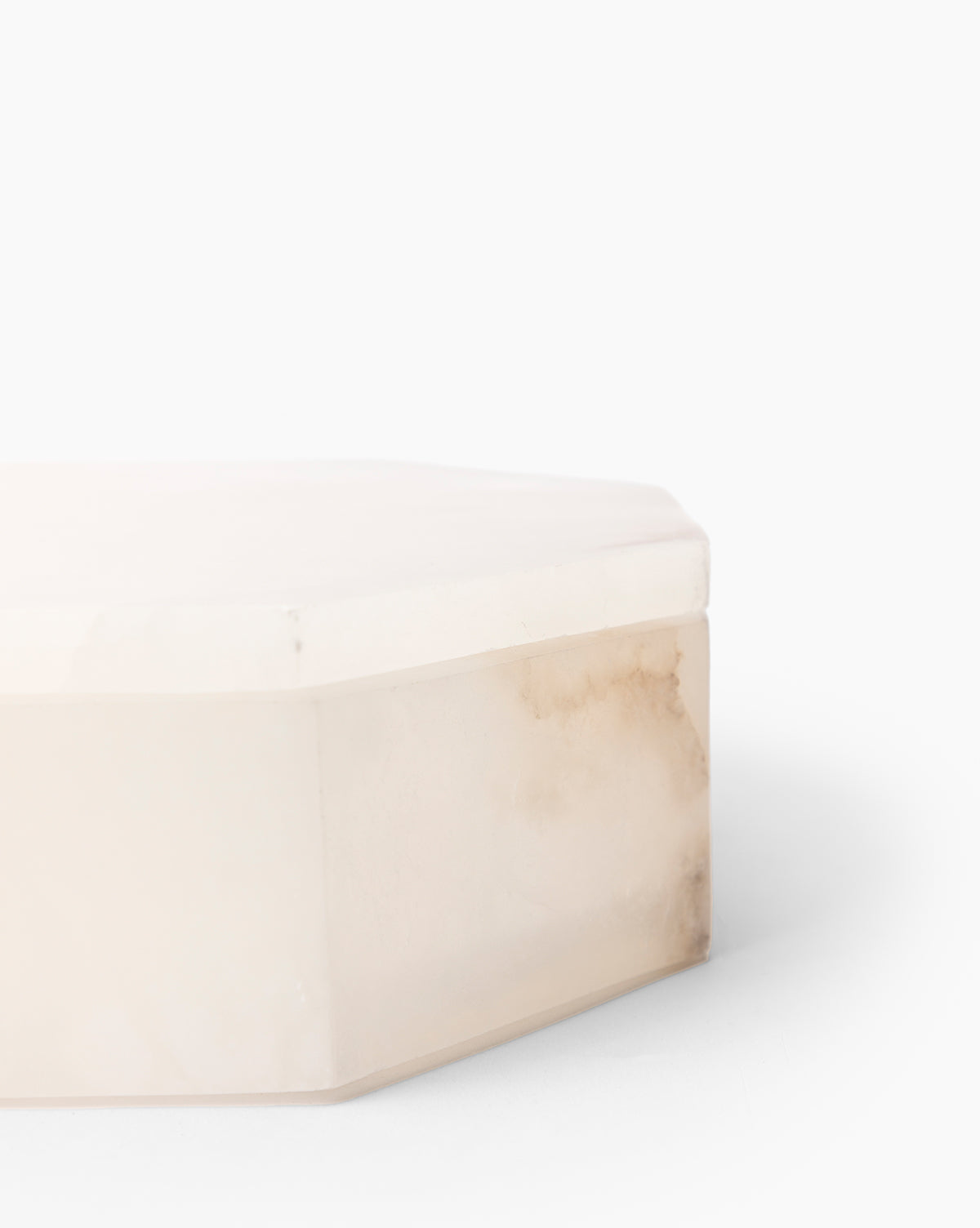 A close-up view of the Sonya Alabaster Box, an octagonal white marble decorative box with a lid and subtle natural brown veining, set against a plain white background.