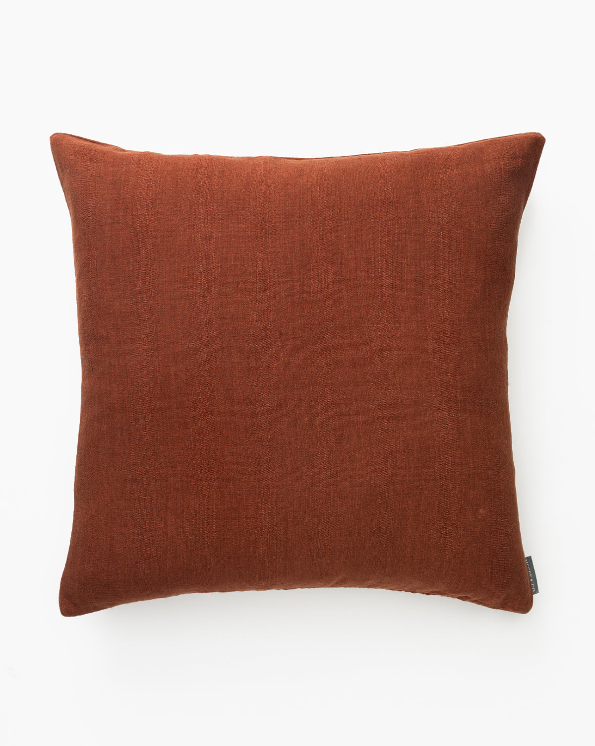 A rust-colored, square Teagan Pillow Cover with a soft, handwoven texture is shown against a plain white background, by McGee & Co.