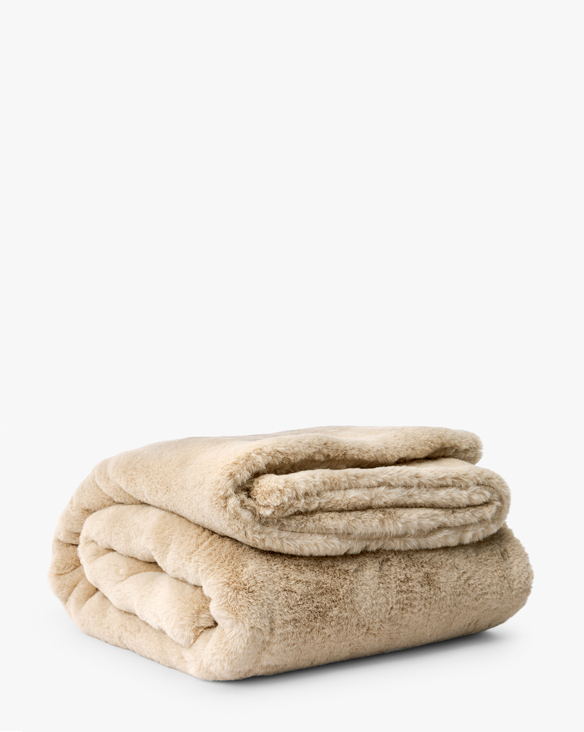 The Tove Faux Fur Throw, in plush beige with a soft, fluffy texture, is neatly folded and shown against a white background—an ideal accent to add warmth and style to your cozy home, by McGee & Co.