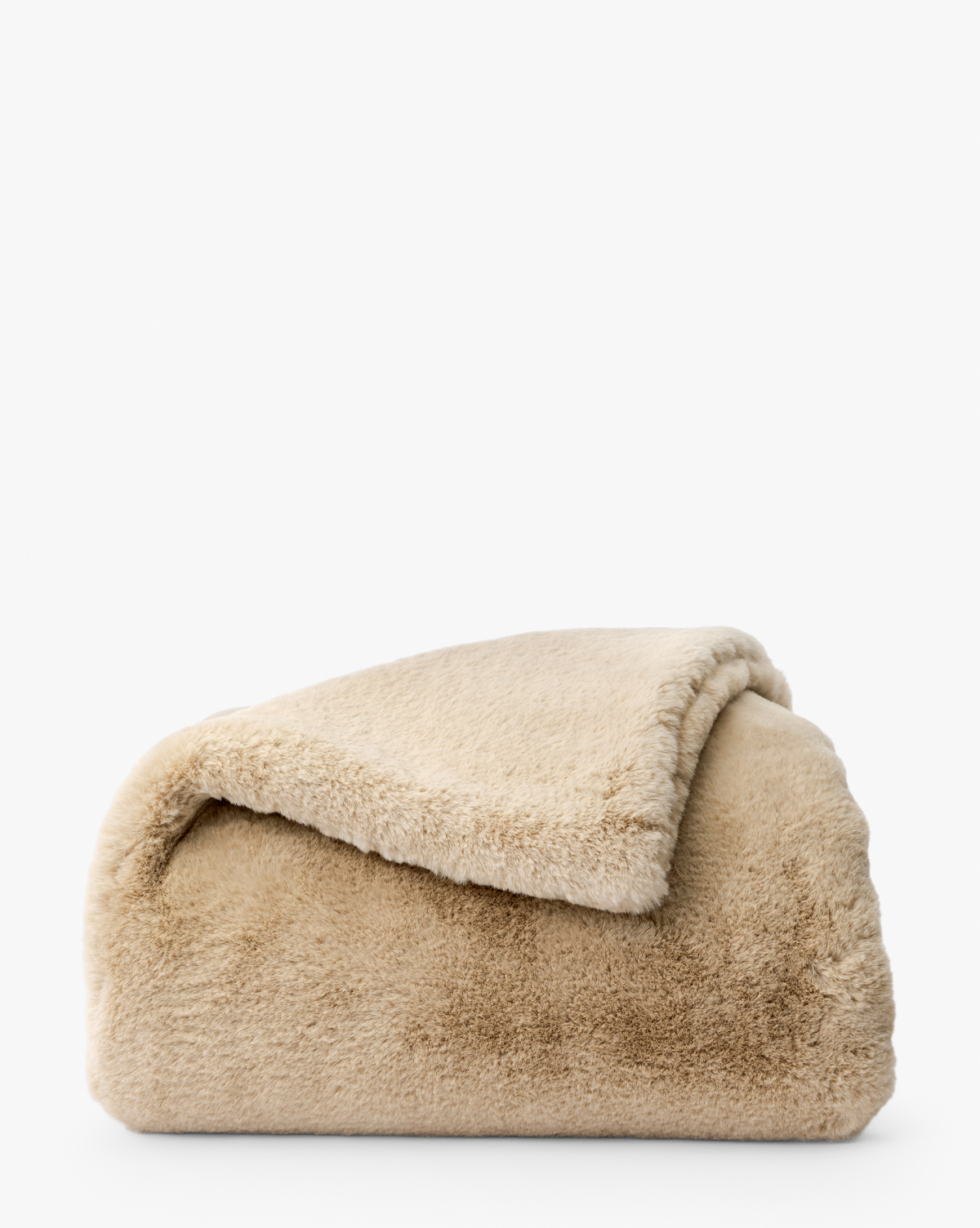 The Tove Faux Fur Throw, in soft beige and plush texture, is neatly folded with one corner turned over on a white background—an ideal cozy accent for any home, by McGee & Co.