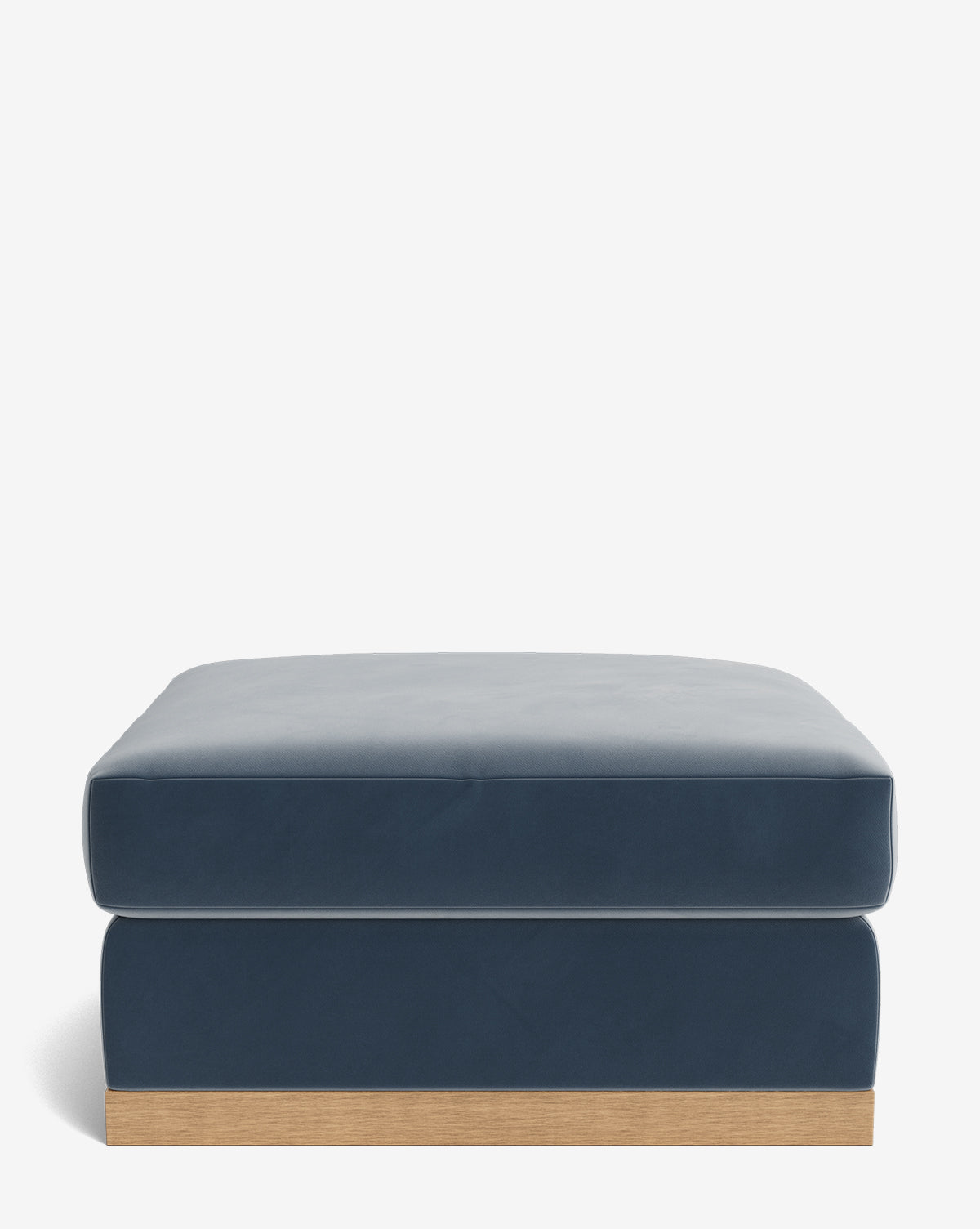 The Vernon Modular Ottoman features a modern rectangular design in navy blue velvet upholstery with a smooth finish and a light wooden base, displayed against a plain white background, by McGee & Co.