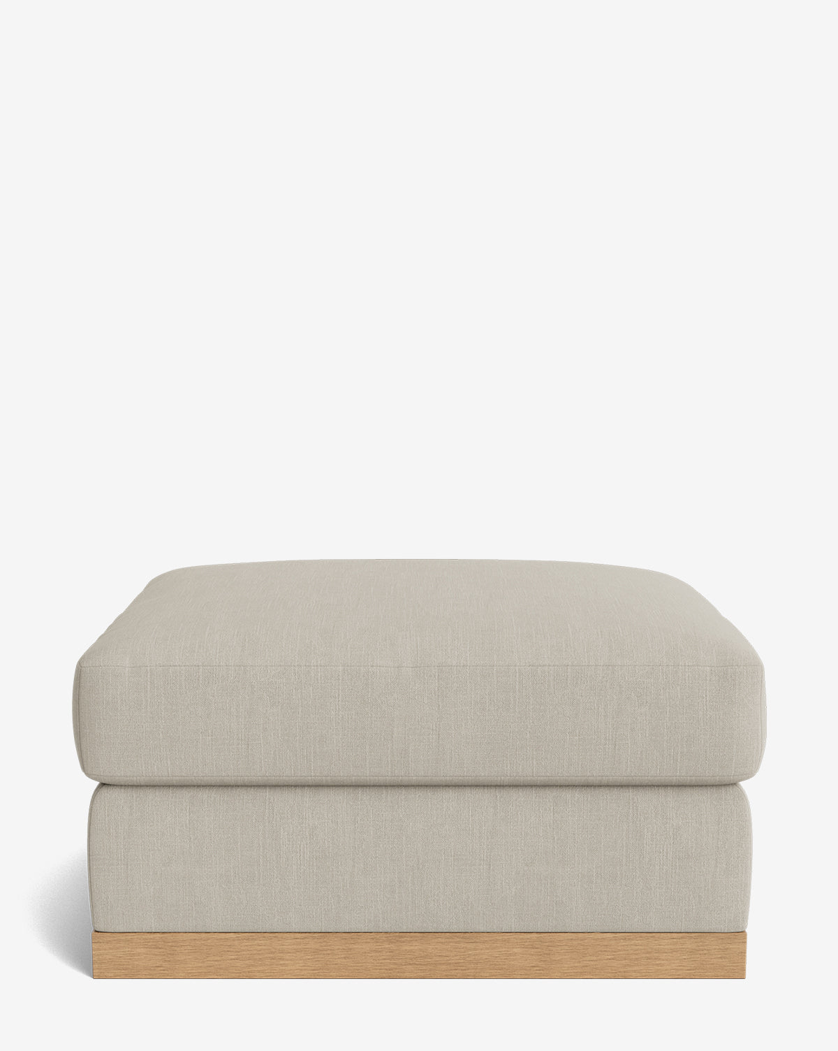 The Vernon Modular Ottoman is a rectangular, light gray piece with a flat cushion top and wooden base, displayed against a plain white background by McGee & Co.