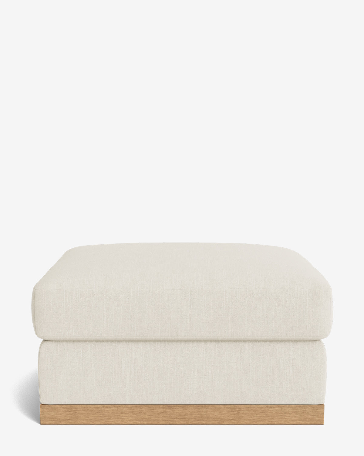 The Vernon Modular Ottoman features a simple rectangular design with a light beige upholstered cushion and a wooden base, showcased against a plain white background, by McGee & Co.