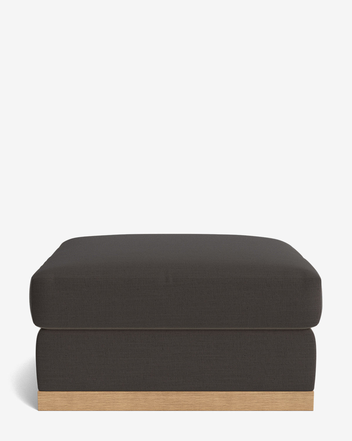 The Vernon Modular Ottoman features a modern rectangular design with a thick velvet cushion and a light wooden base, displayed against a white background, by McGee & Co.