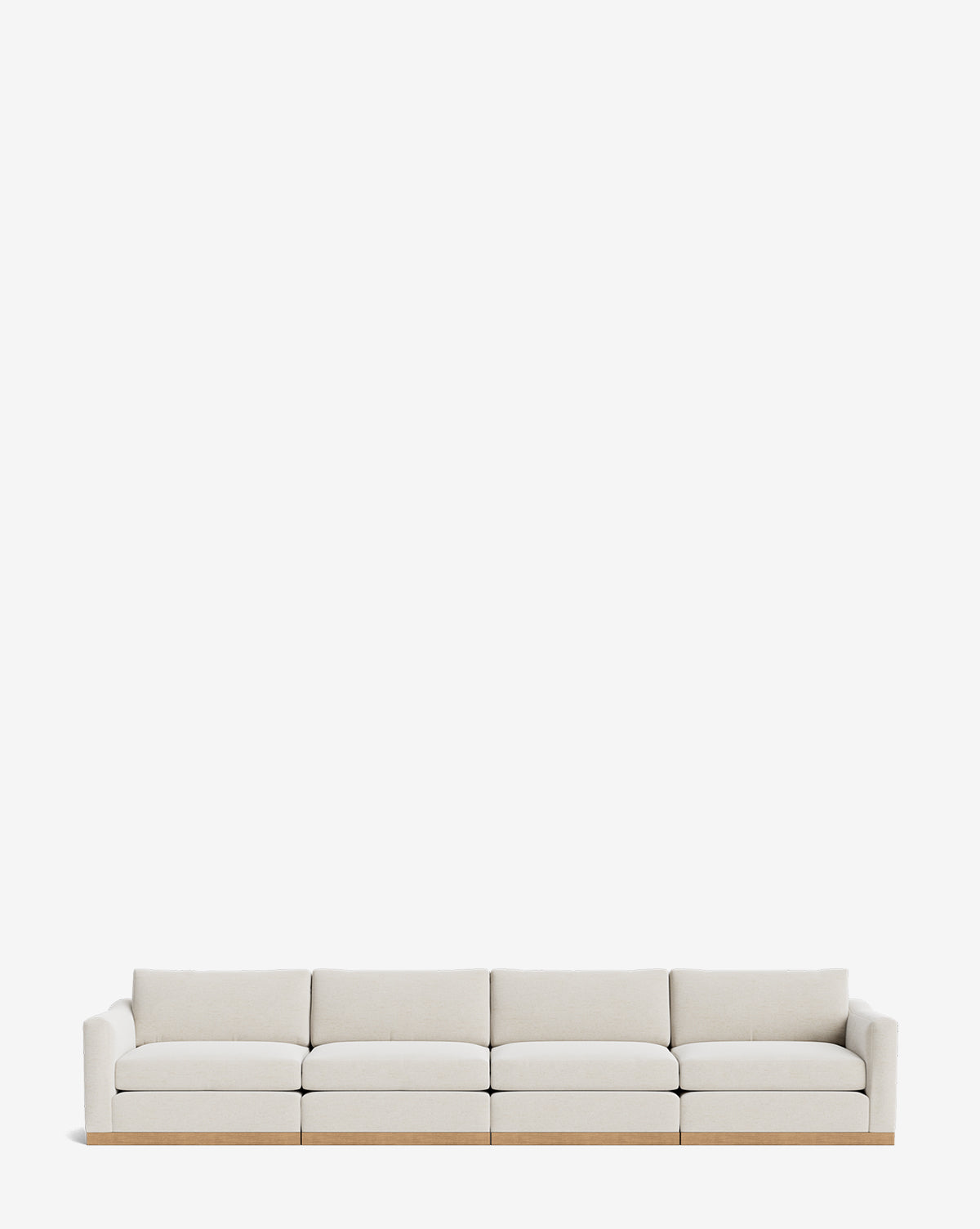 The Vernon Modular Sofa (121-157) is a modern, customizable light beige sofa with a low back and arms, wooden base, and is shown against a plain white background by McGee & Co.