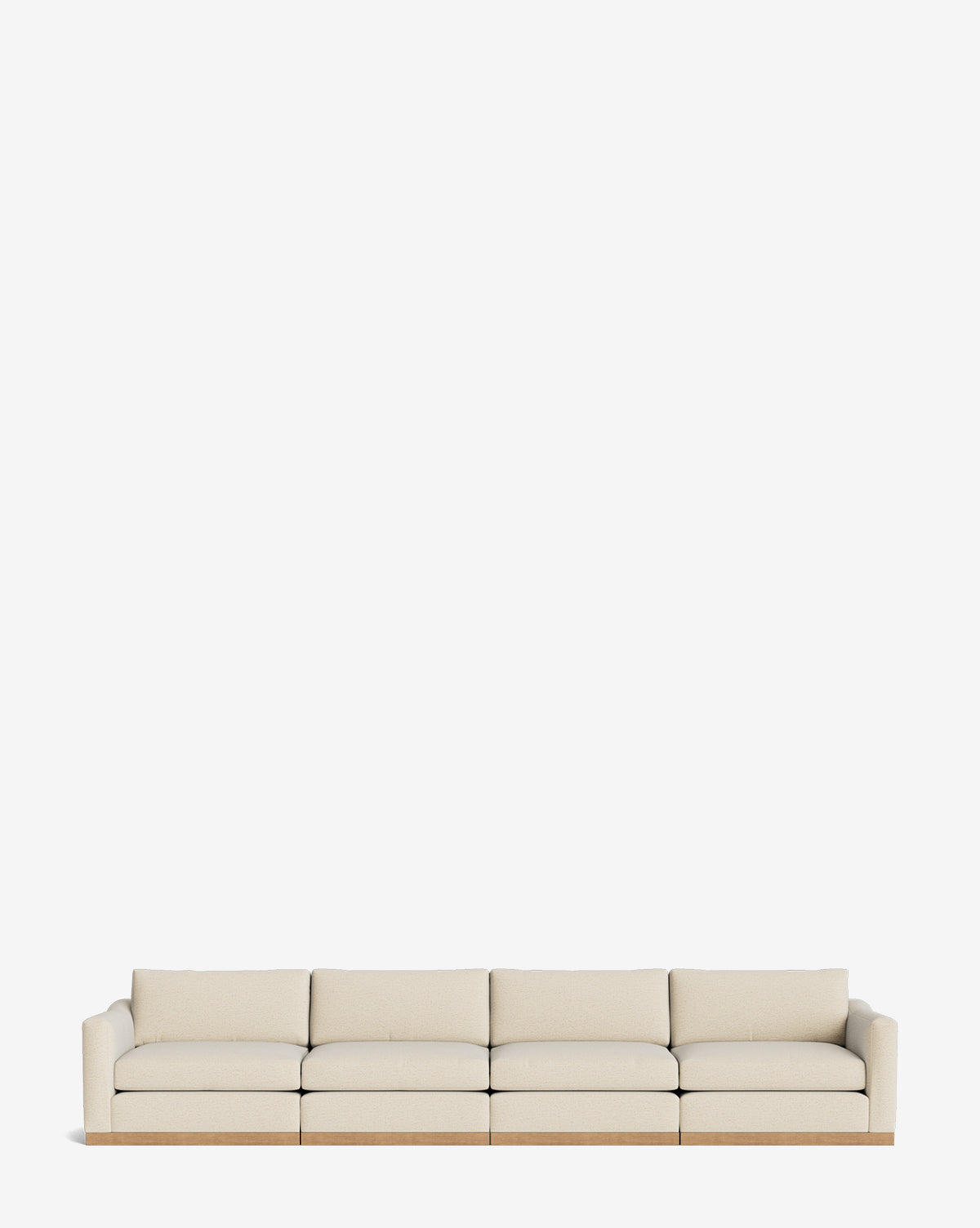 The Vernon Modular Sofa (121-157), a modern beige velvet piece with four seat cushions and low arms, is centered against a plain white background, by McGee & Co.