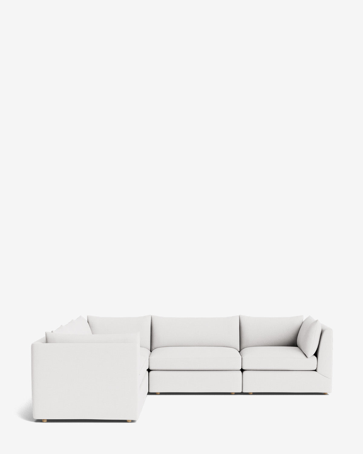 The Makerspalm Vivienne Modular L Sectional, a modern light gray sofa with clean lines and plush cushions, is shown against a plain white background. Two white throw pillows rest on the left section of the sofa. McGee & Co.