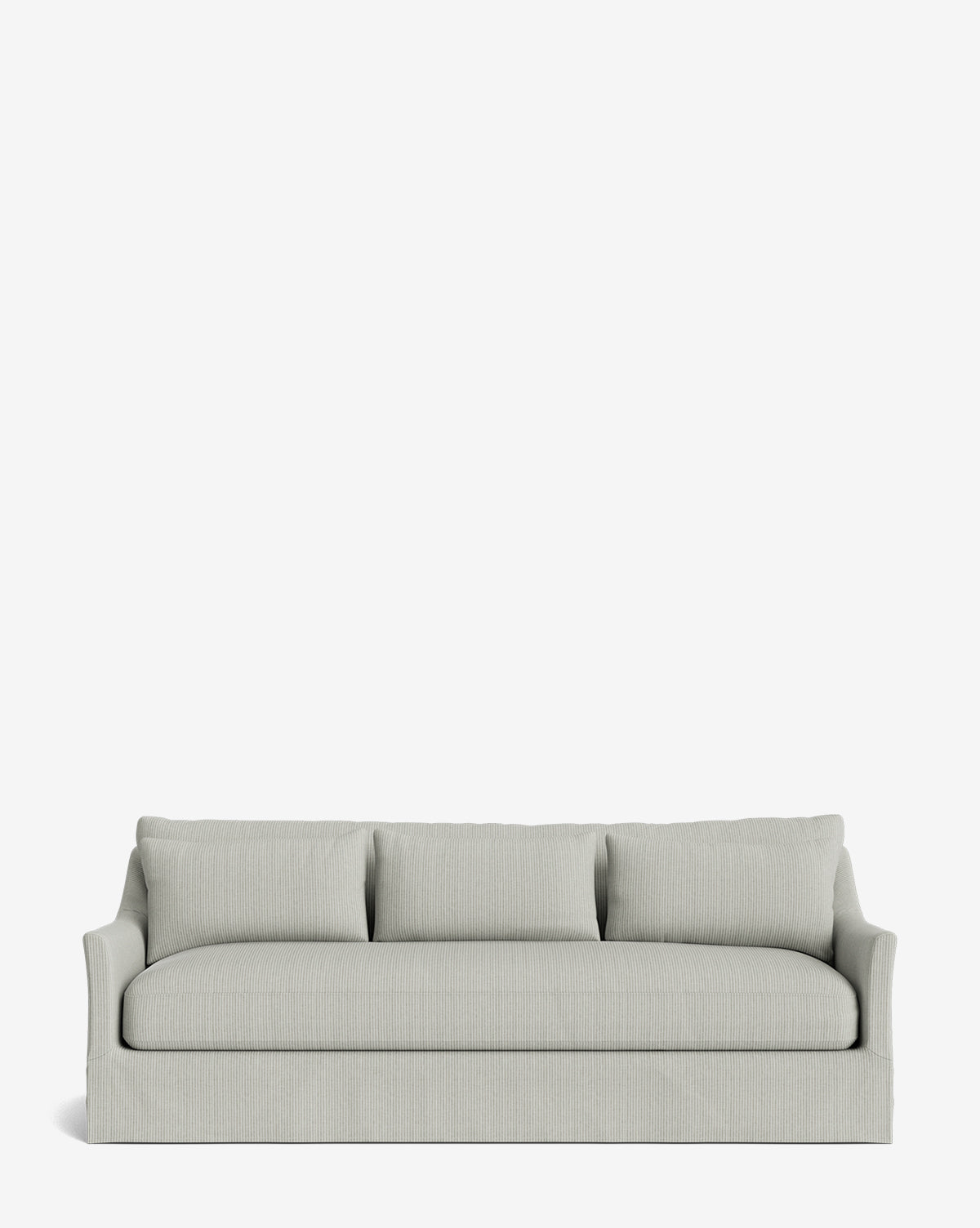 The Wilhelmina Deep Slipcover Sofa (85-110) is a light gray three-seat sofa with a skirted base and three back cushions, offering luxurious comfort against a plain white background by McGee & Co.