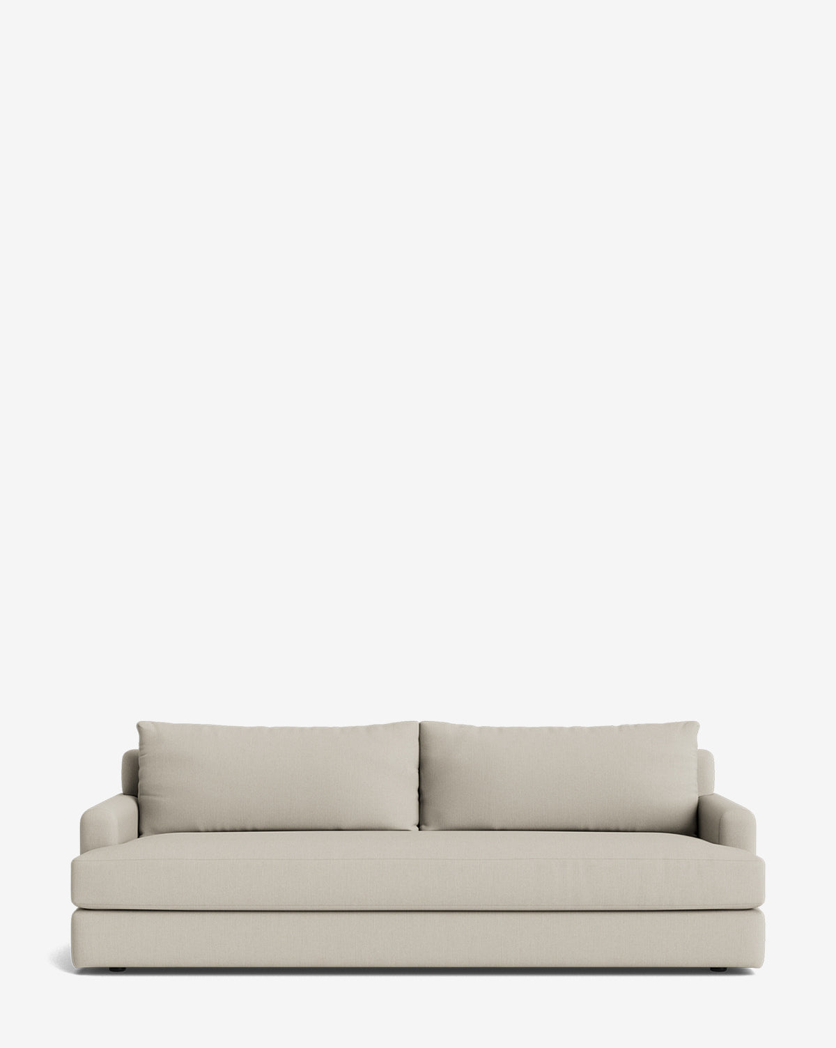 The Winthrop Sofa 90 is a modern, light beige, made-to-order sofa with two large back cushions and straight, low armrests, shown against a plain white background by McGee & Co.