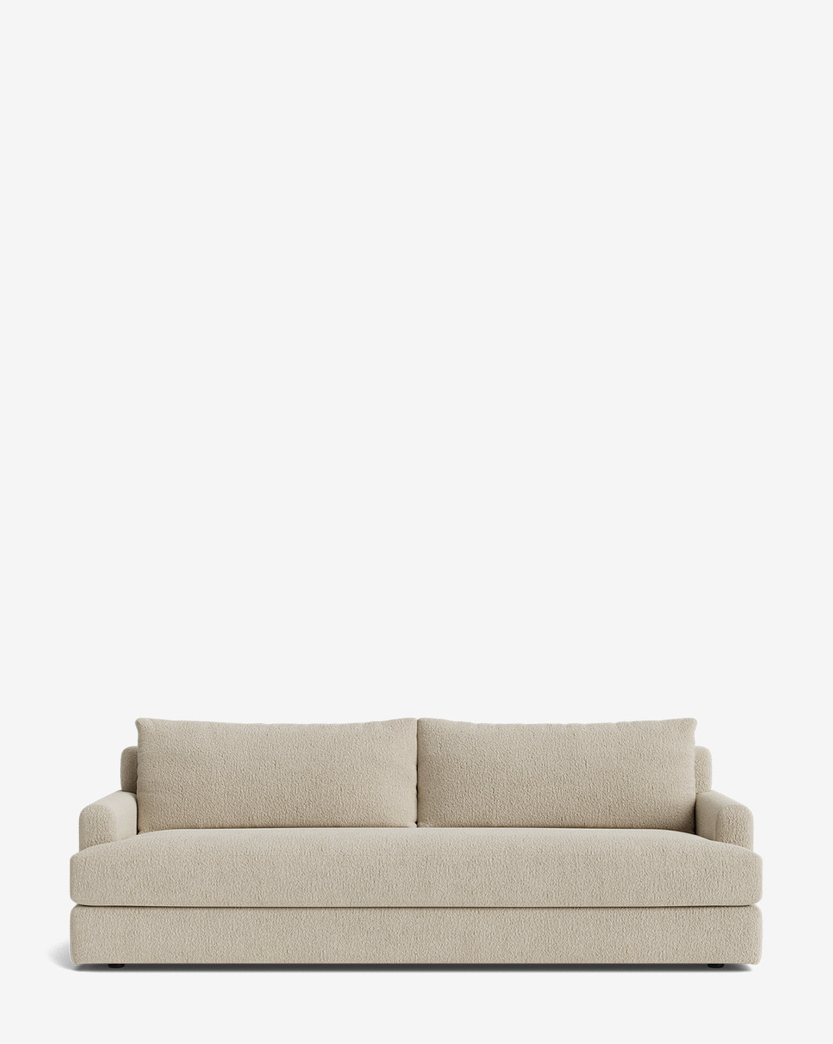 The Winthrop Sofa 90 is a beige, made-to-order sofa with two seat and two large back cushions, straight arms, and a minimalist design, shown against a plain white background by McGee & Co.