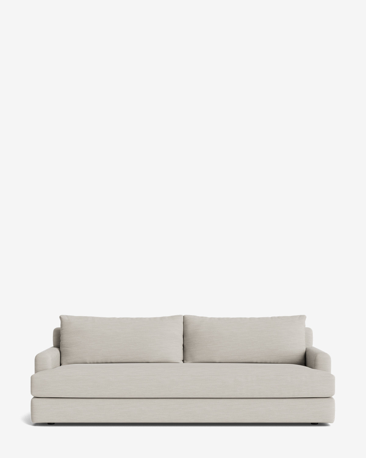 The Winthrop Sofa 90 is a modern, light gray sofa with two large back cushions and low armrests. This made-to-order piece features a clean, minimalist design and is shown against a plain white background, by McGee & Co.