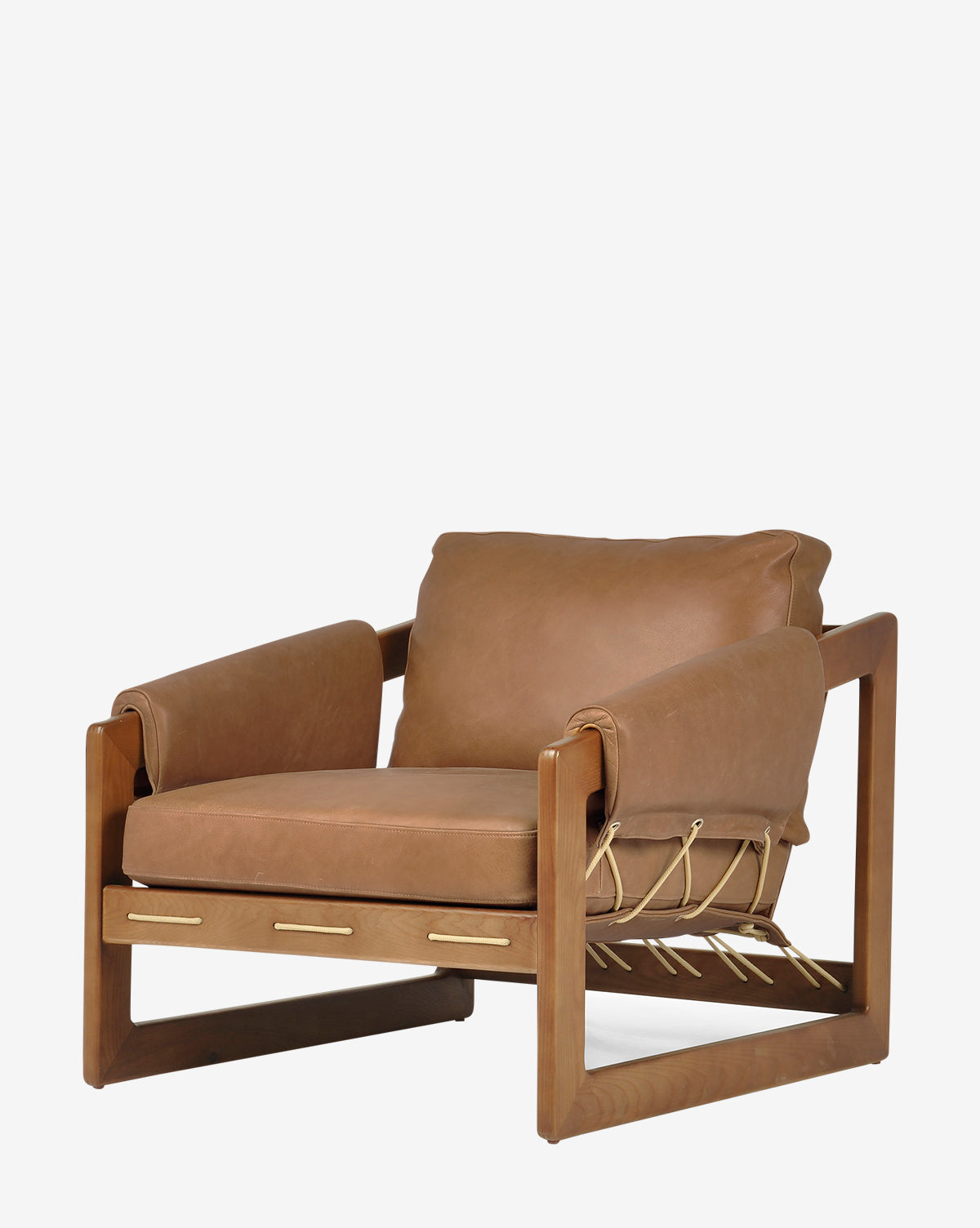 The Barker Lounge Chair features a wooden frame, top-grain leather tan cushions, and rope detailing along the sides and back, taking inspiration from midcentury sling seating, by McGee & Co. Shown here against a plain white background.
