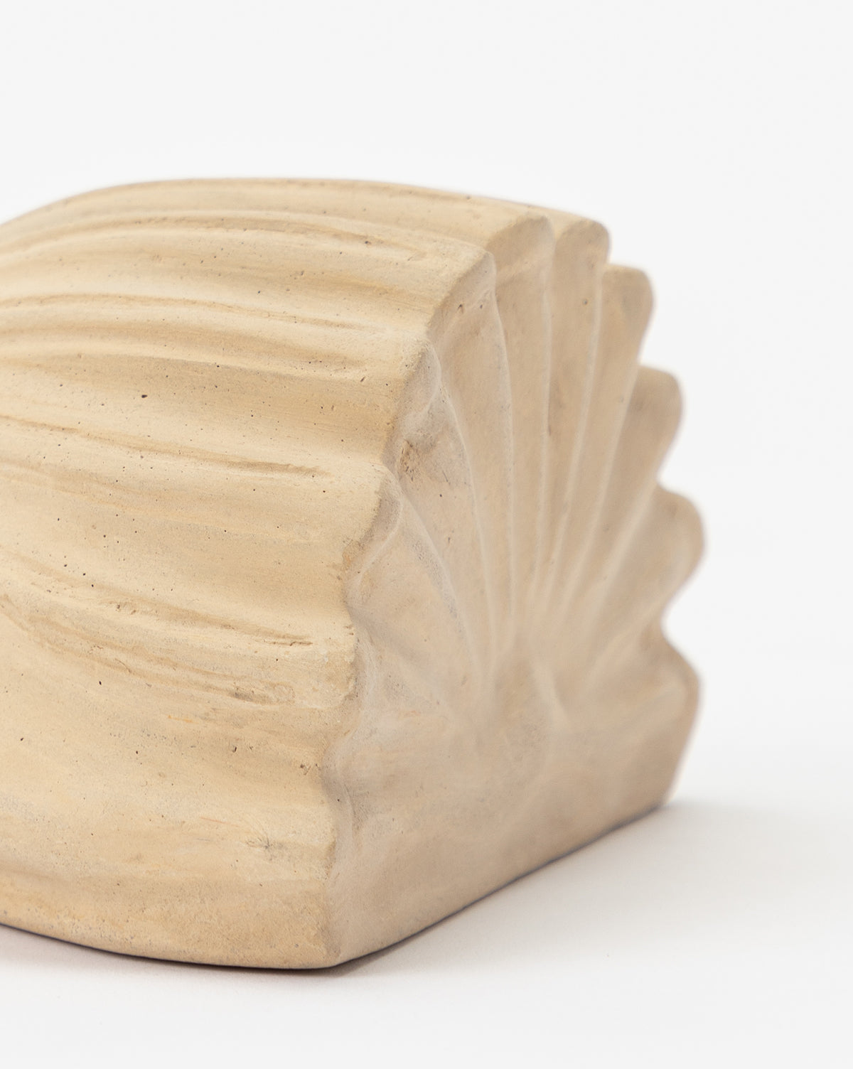 A close-up of the Baroque Shell Object, a beige composite stone piece with a ridged, shell-like pattern and matte finish, set against a plain white background.