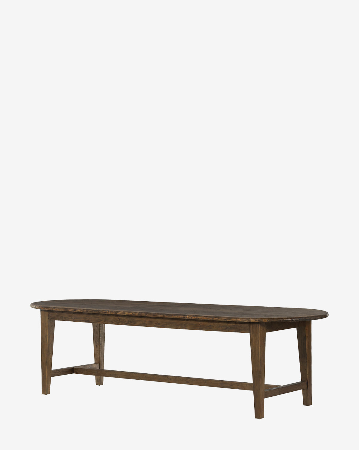 The Constance Dining Table showcases a long oval design made from solid pine in a dark brown finish with four angled legs, adding modern farmhouse charm to your dining space, by McGee & Co. Displayed against a plain white background.