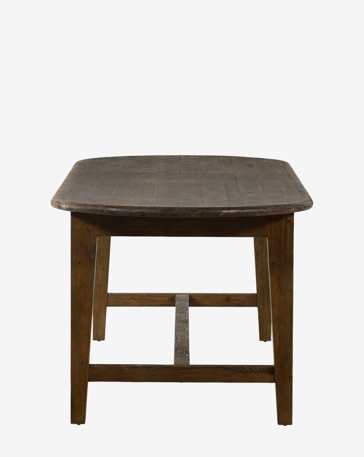 The Constance Dining Table features solid pine construction, a dark rustic finish, sturdy legs, and a rectangular shape. Its slightly textured surface adds charm, making it ideal for modern farmhouse interiors against white backdrops by McGee & Co.