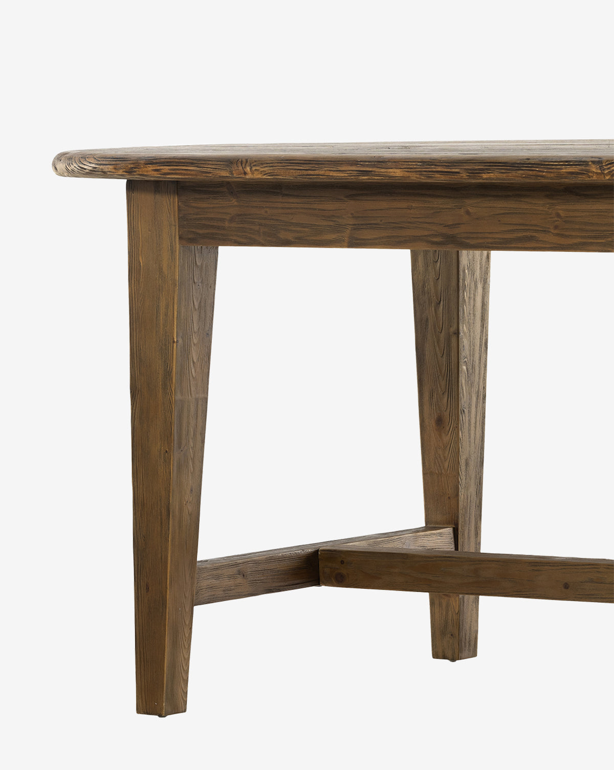 A close-up of the Constance Dining Table highlights its modern farmhouse charm, featuring solid pine construction with angled legs and a crossbar support, set against a plain white background by McGee & Co.