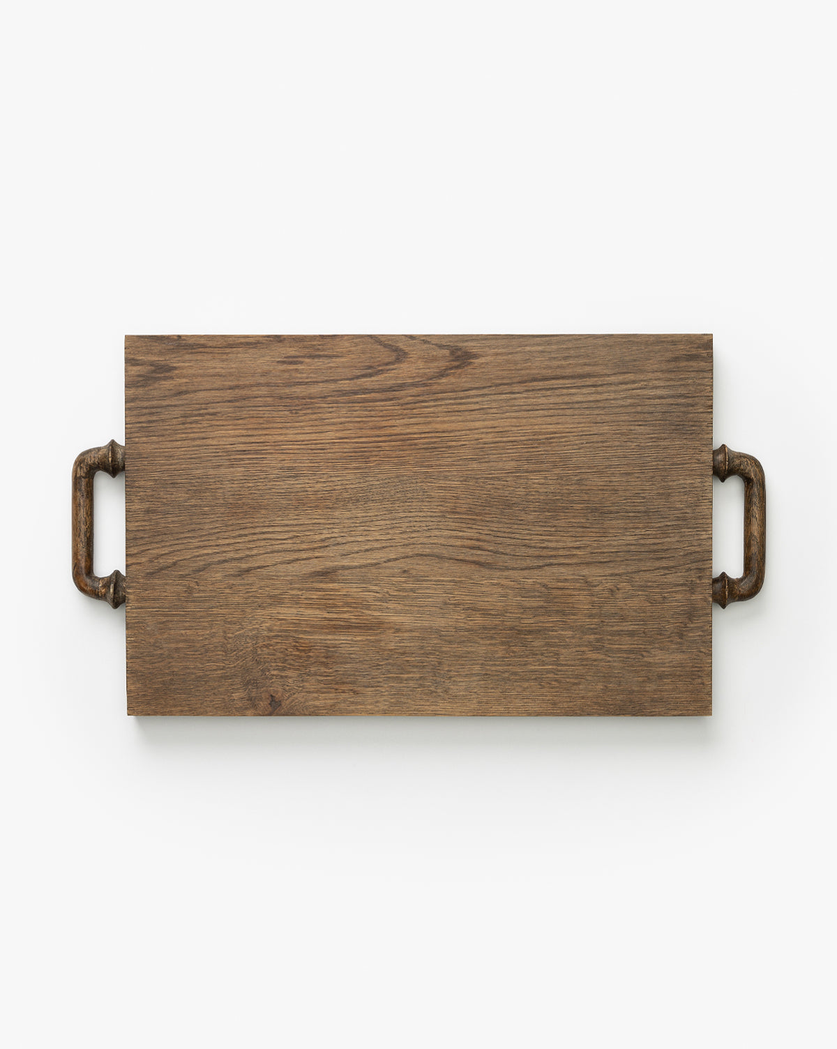 The Fordham Board is a rectangular solid oak serving tray with visible wood grain and metal handles on each short end, ideal as a charcuterie serving board, shown on a white background by McGee & Co.