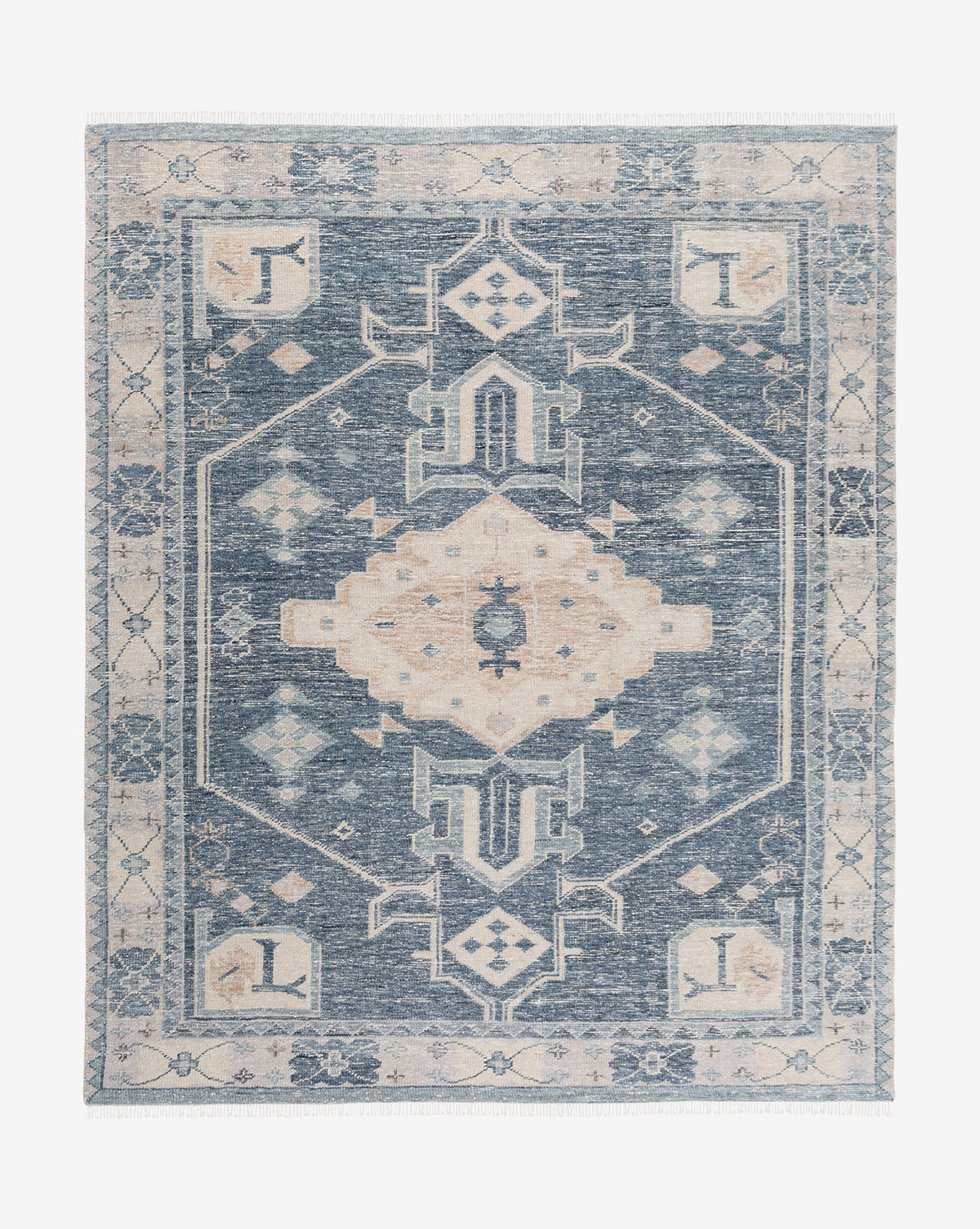 The Inverness Hand-Knotted Rug is a rectangular navy wool rug with a geometric central medallion, symmetrical motifs, and a floral and abstract border, by McGee & Co. This traditional rug features a vintage, distressed look by McGee & Co.