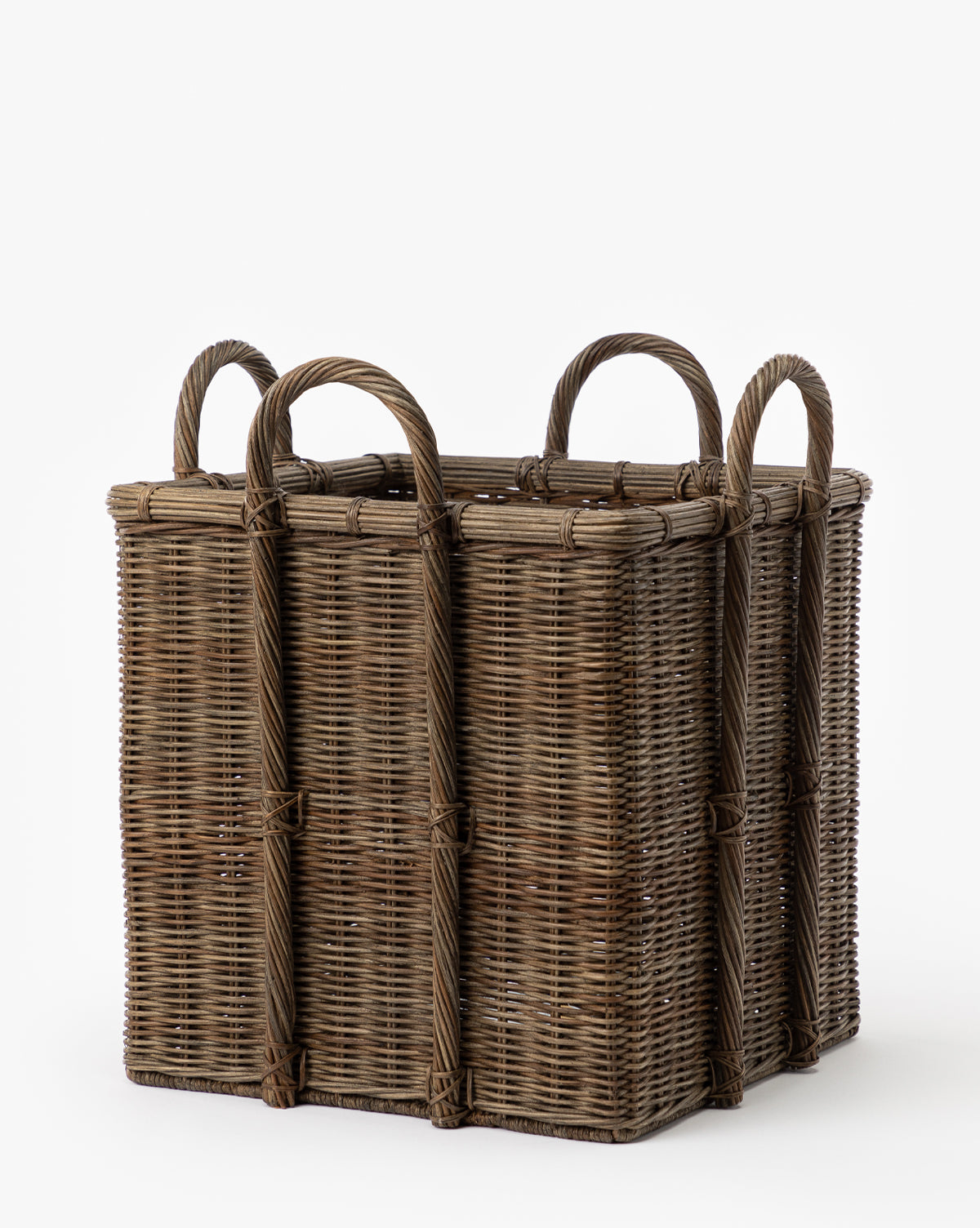 The Jacinta Woven Basket is a square, brown wicker basket with four sturdy handles, featuring a natural woven texture for easy storage or carrying. Shown against a plain white background.