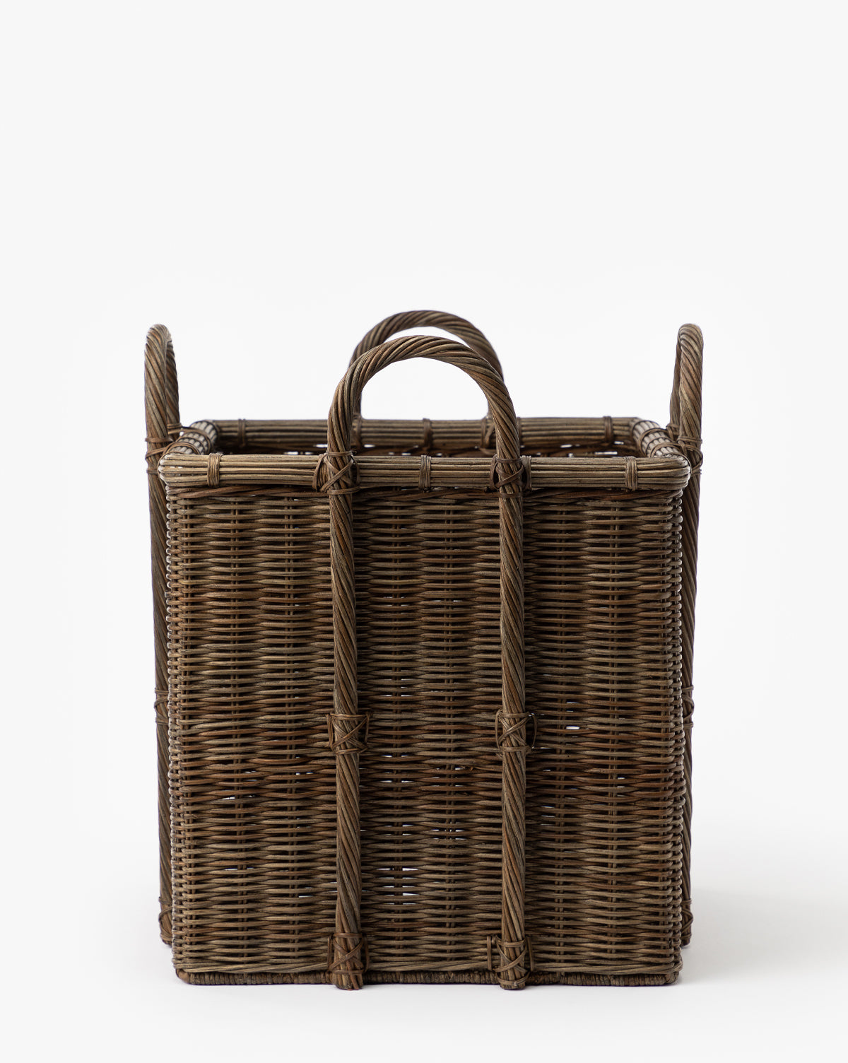The Jacinta Woven Basket is rectangular with two upright side handles, an open top, and an organic wicker texture. Shown against a plain white background.