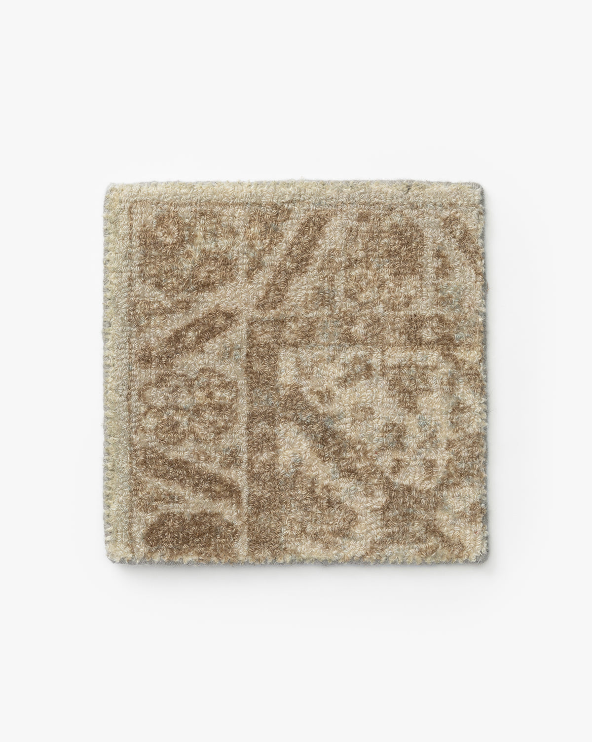 A square swatch of the Lambeth Hand-Tufted Wool Rug in beige, featuring a subtle geometric and floral pattern, displayed on a plain white background by McGee & Co.