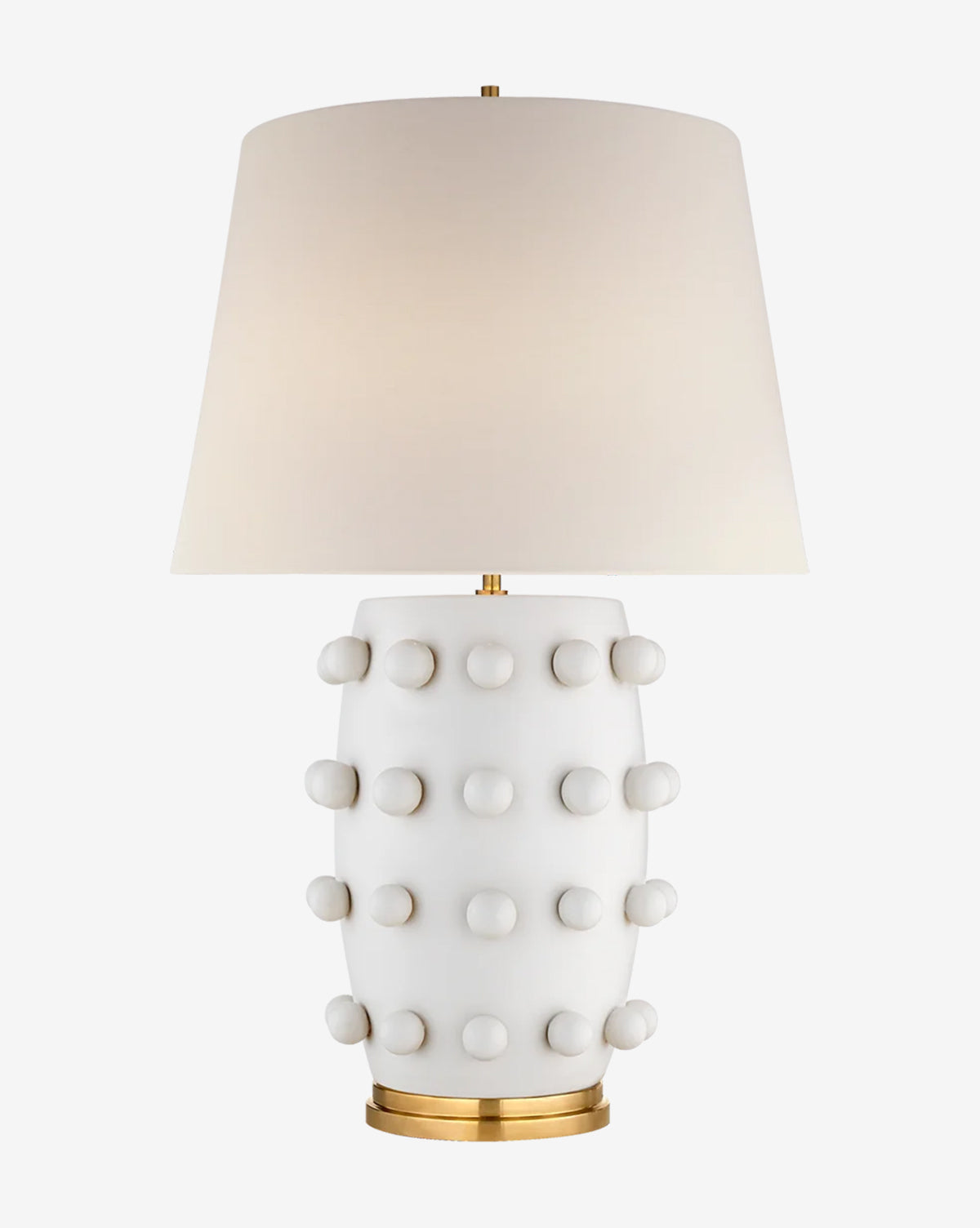 The Linden Table Lamp by Visual Comfort & Co. Signature features a white ceramic base with raised knobs, a gold-colored circular base, and a white linen shade for a sleek, modern look by McGee & Co.