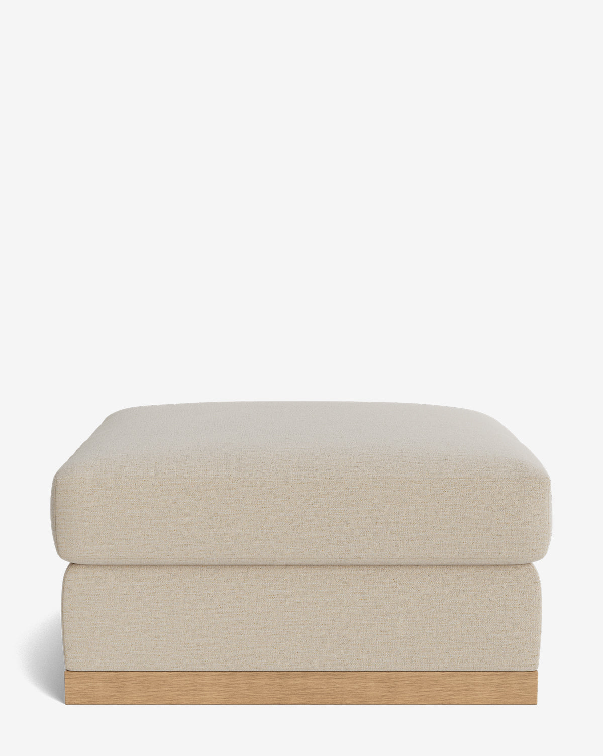 The Vernon Modular Ottoman by Community features a beige velvet cushion and a light wood base, shown against a plain white background. McGee & Co.