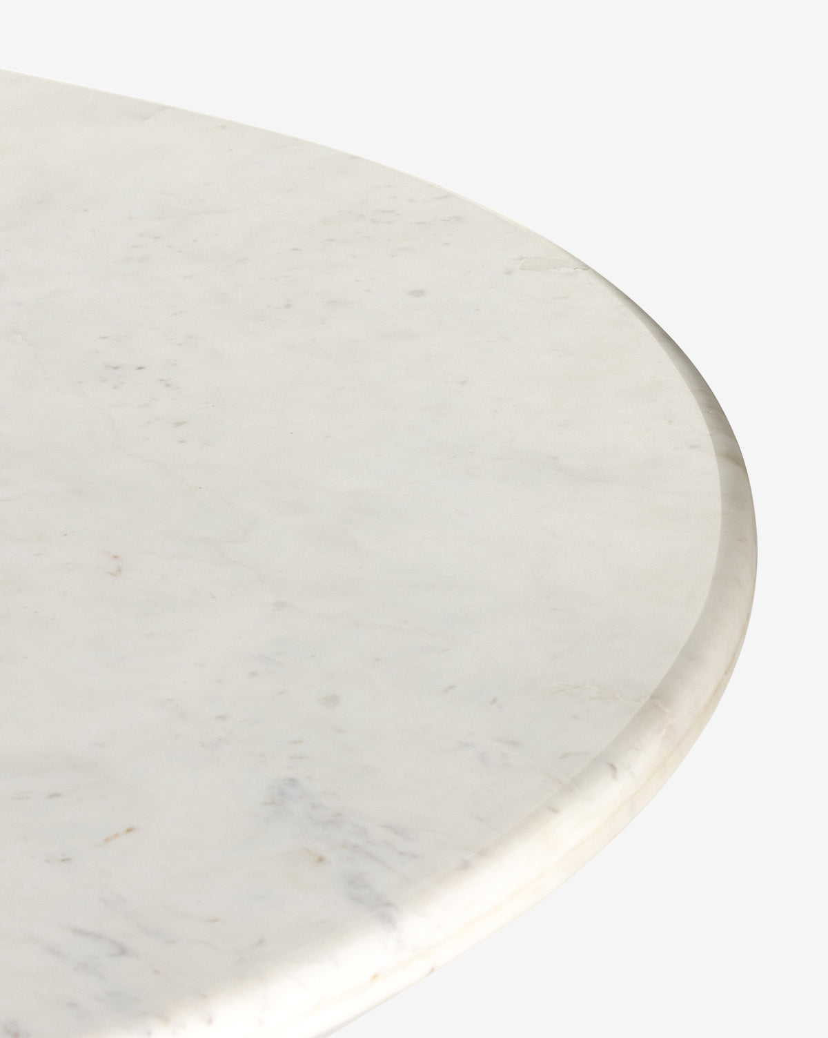 Close-up of the Patrick Dining Table, a round white marble piece with subtle gray veining and a smooth, polished edge, highlighting refined Italian design against a plain white background, by McGee & Co.