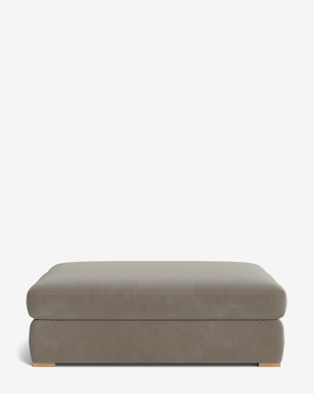 The Macy Upholstered Ottoman by Community is a large, rectangular taupe piece with a smooth surface and low wooden feet, ideal as versatile living room furniture, shown against a plain white background by McGee & Co.