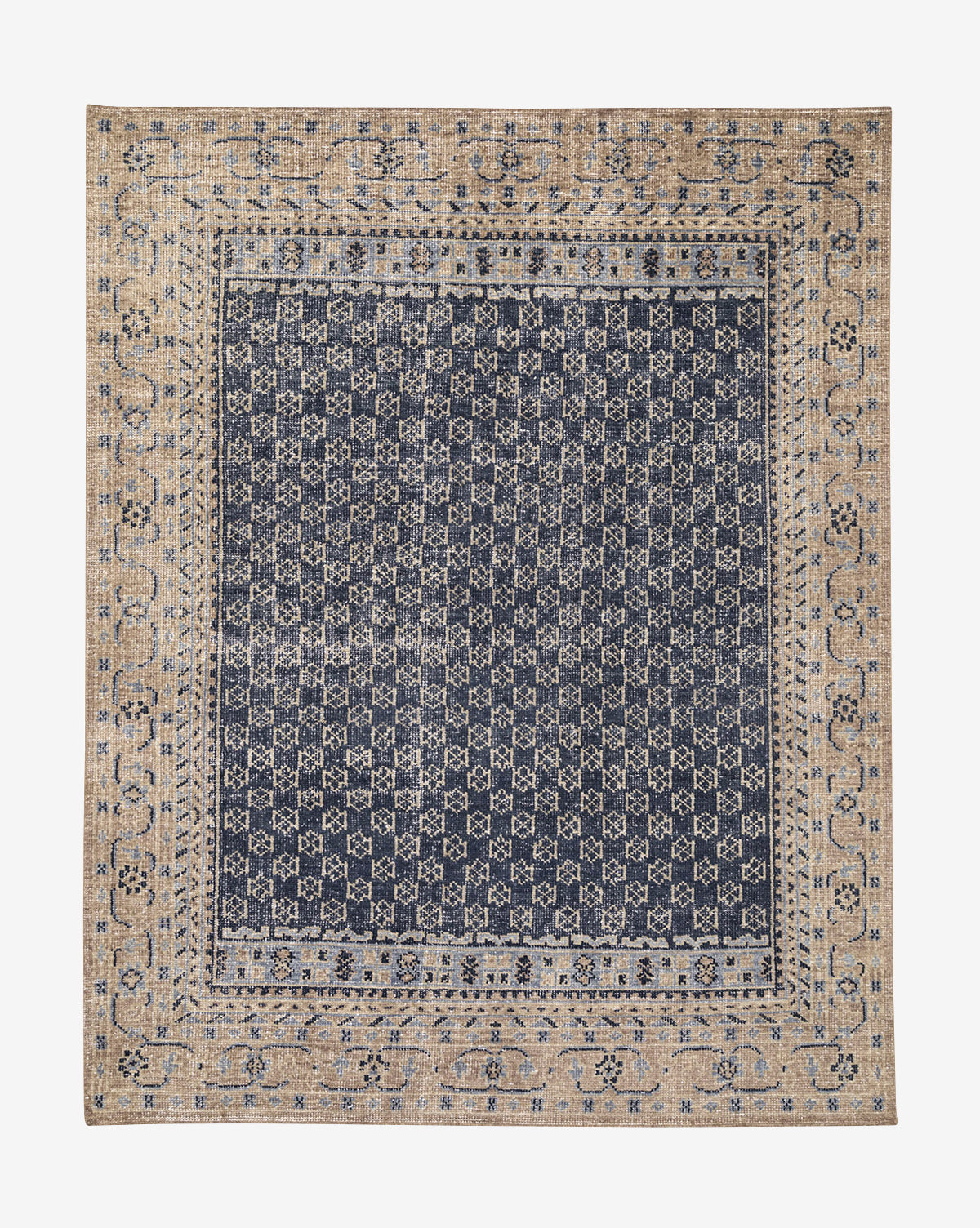 The Obeetee Anya Indigo Hand-Knotted Wool Rug is square-shaped with a dense geometric grid in navy and beige at the center, accented by a detailed floral border for a striking transitional look, McGee & Co.