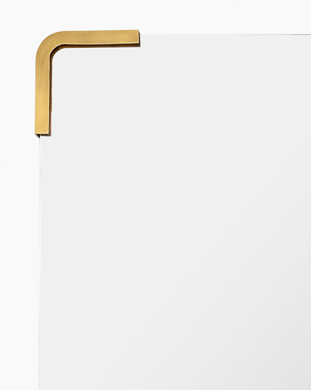 Close-up of the Mare Mirrors top left corner, featuring its frameless design with a gold metal bracket, highlighting its modern style against a plain white background, by McGee & Co.