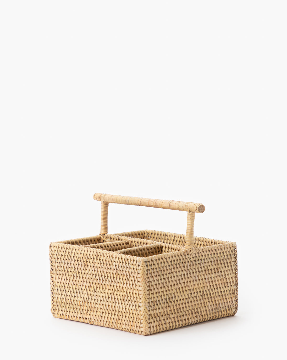 The Rattan Utensil Caddy is a square, woven organizer with a sturdy handle and divided compartments, ideal as a picnic utensil holder, by McGee & Co. Shown against a plain white background.