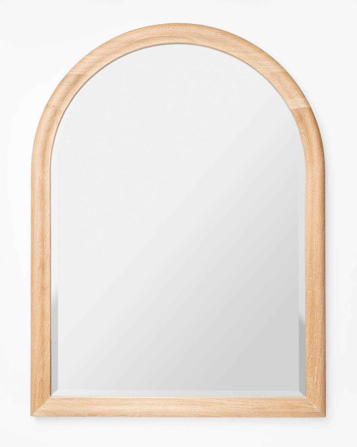 The Reta Arched Wall Mirror features a natural oak wooden frame with a rounded arch top and straight sides and bottom, displayed against a plain white background, by McGee & Co.