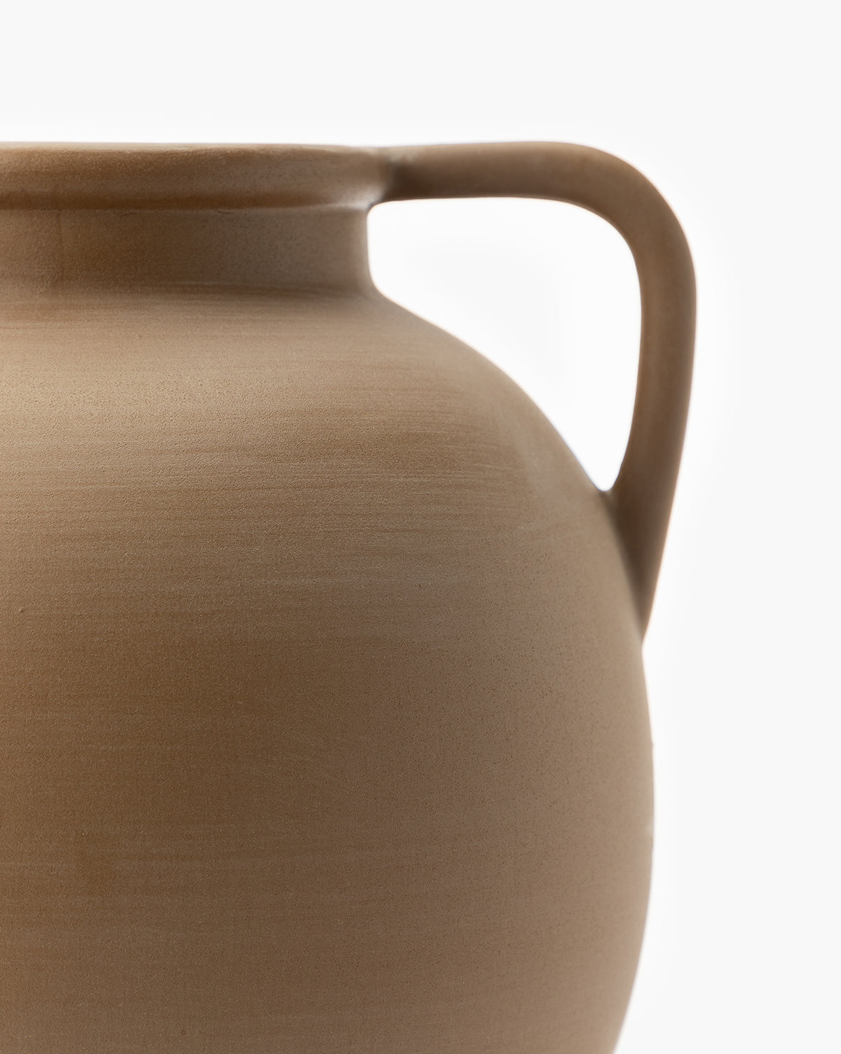 Close-up of the Rounded Dual Handled Vase in soft brown, featuring a single curved handle. Only the upper left portion of the vase and handle appear against a plain white background.
