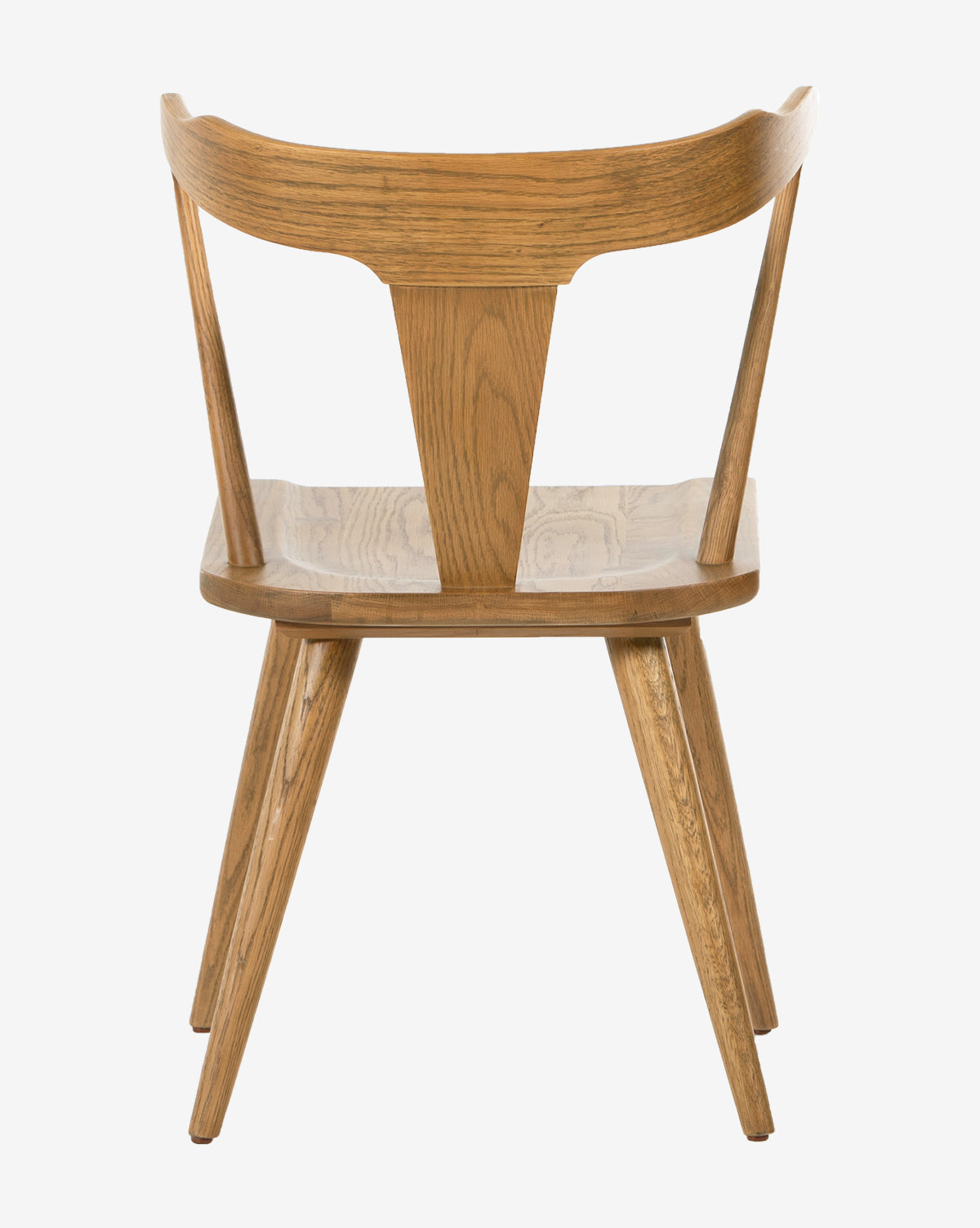 The Ruthie Dining Chair features solid oak, a curved backrest, angled legs, and a broad V-shaped center support, shown from behind against a white background.