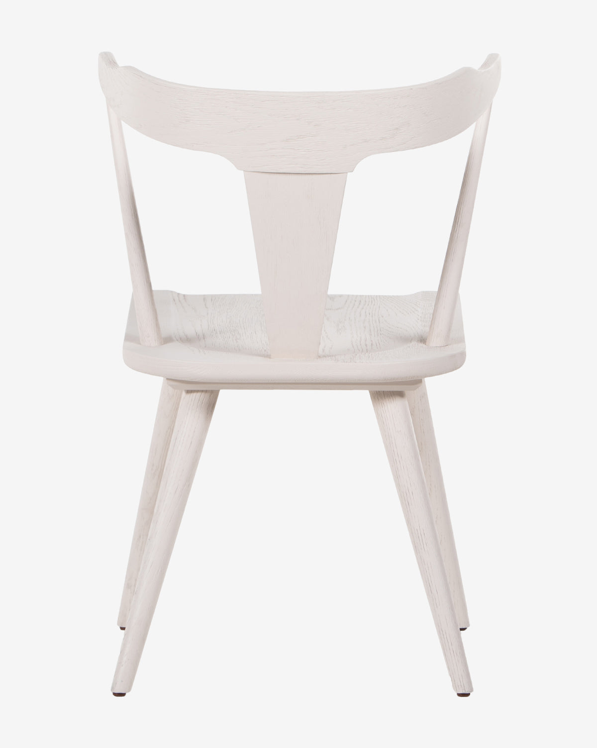 The Ruthie Dining Chair features a white Windsor design with a curved backrest, angled legs, and a triangular rear support, shown from behind against a plain white background.